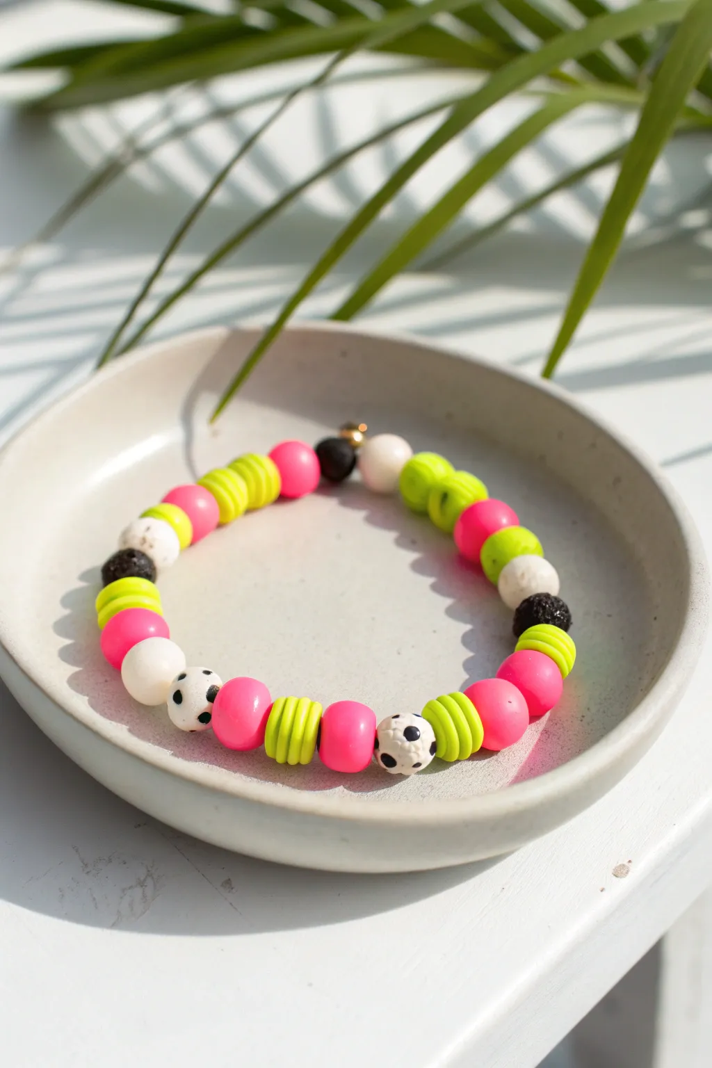 Neon clay disc bracelet balanced with matte black and white beads for a cute modern pop