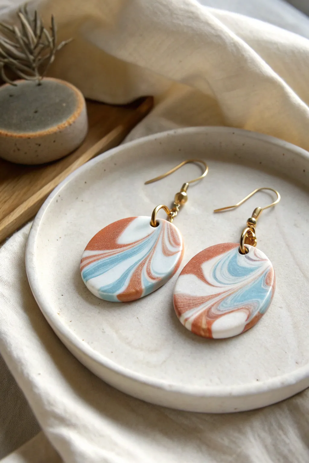 Swirly marble kidney-bean dangles in white, muted blue, and terracotta for a soft boho vibe