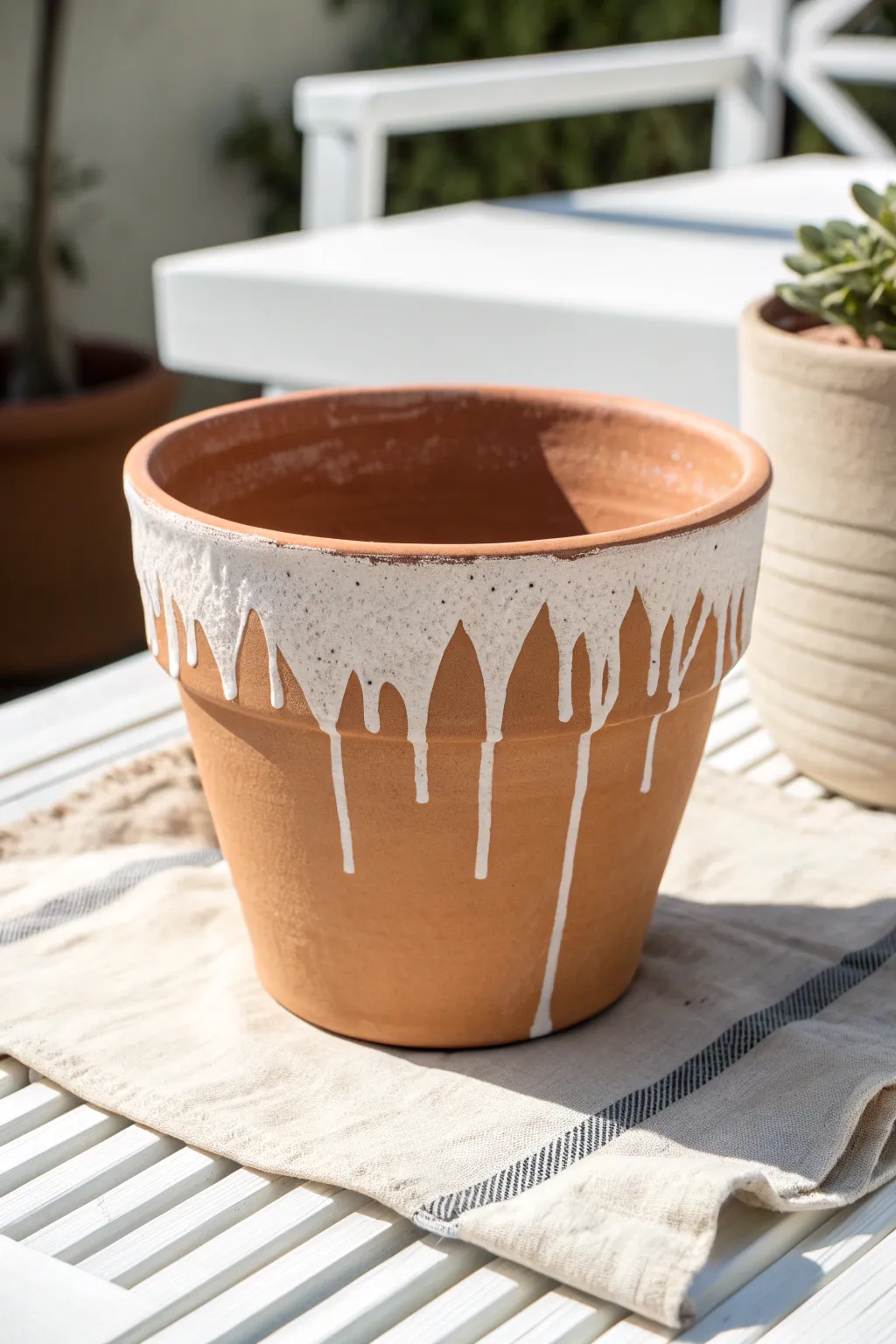 Glaze-look paint drips add a chic, glossy accent to a simple matte flower pot.