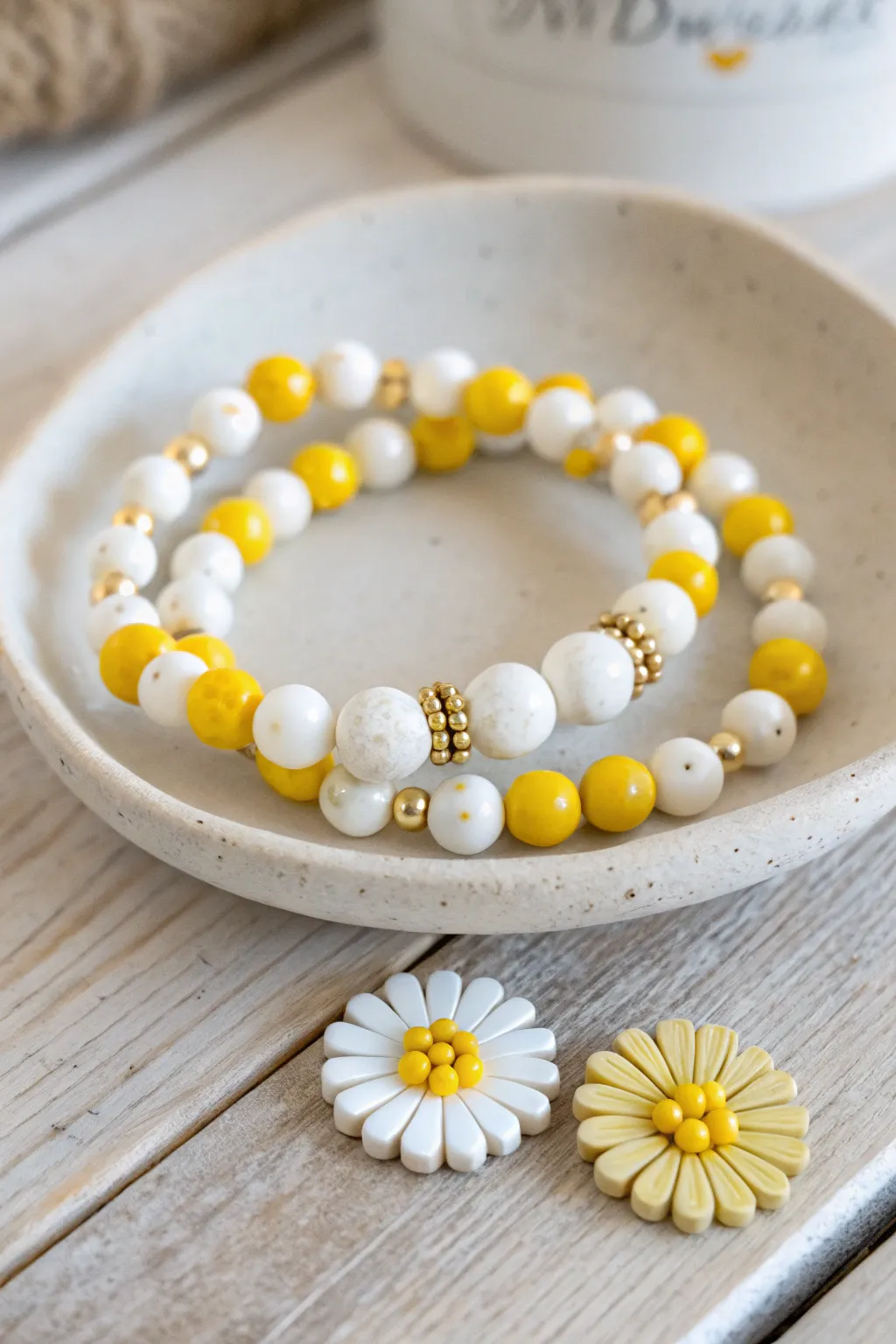Daisy-pop clay bead bracelet stack in sunny yellow and white, simple, cheerful, handmade charm.