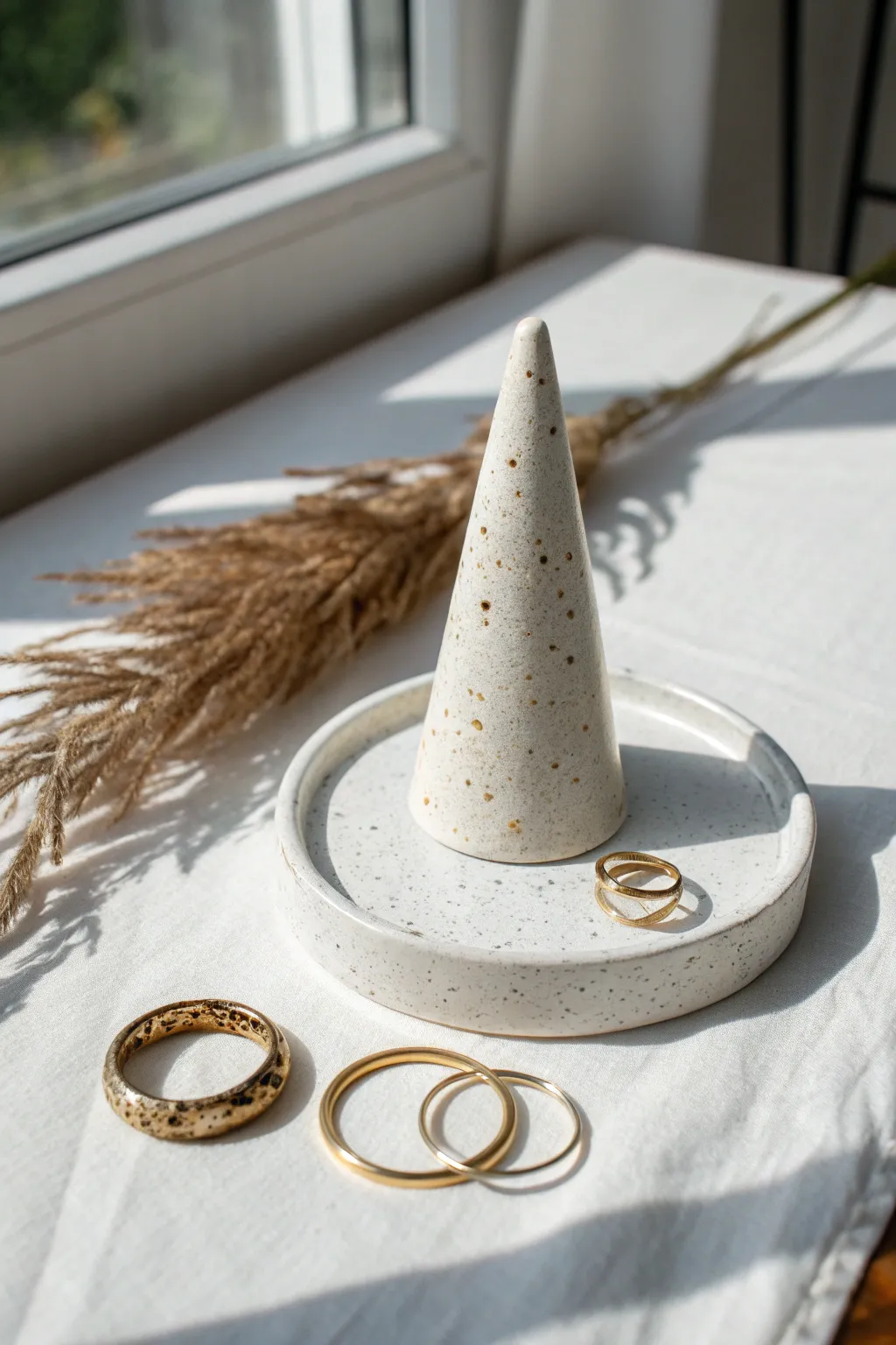 Hand-built ring cone with matching dish, minimalist rings, and warm Scandinavian boho contrast.