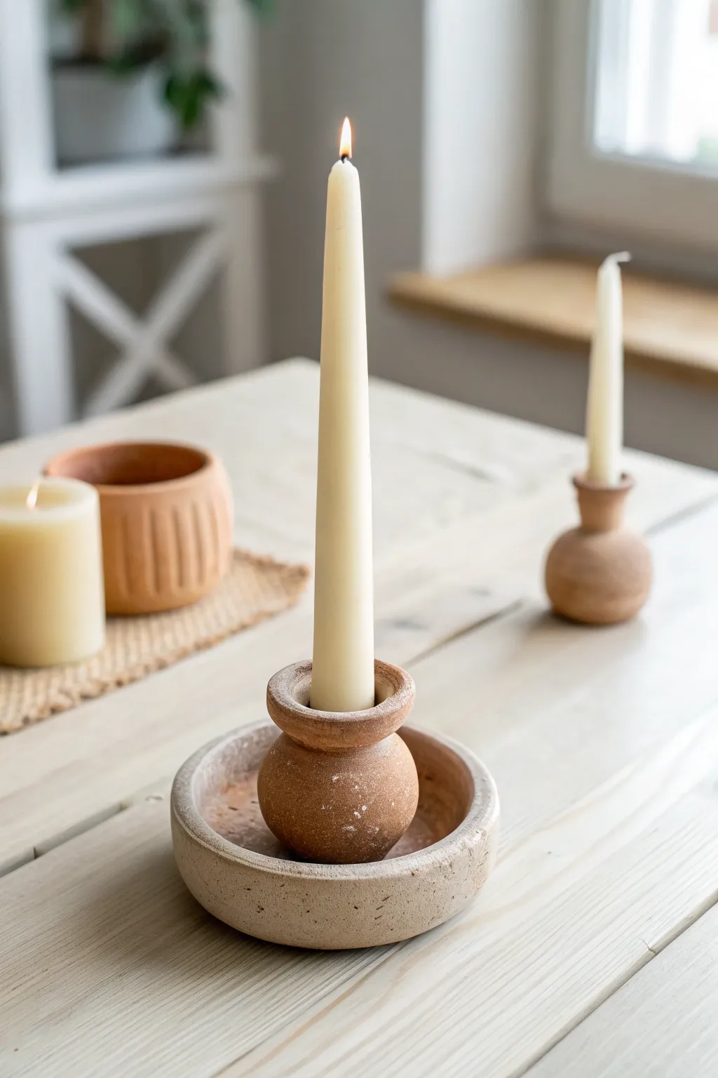 Minimal clay candle holders in warm neutrals, an easy handmade touch for calm cozy interiors.