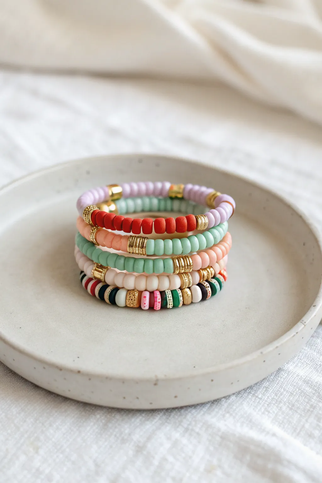 Holiday color combo bracelet stack in clay heishi beads: classic, spooky, and soft pastels.