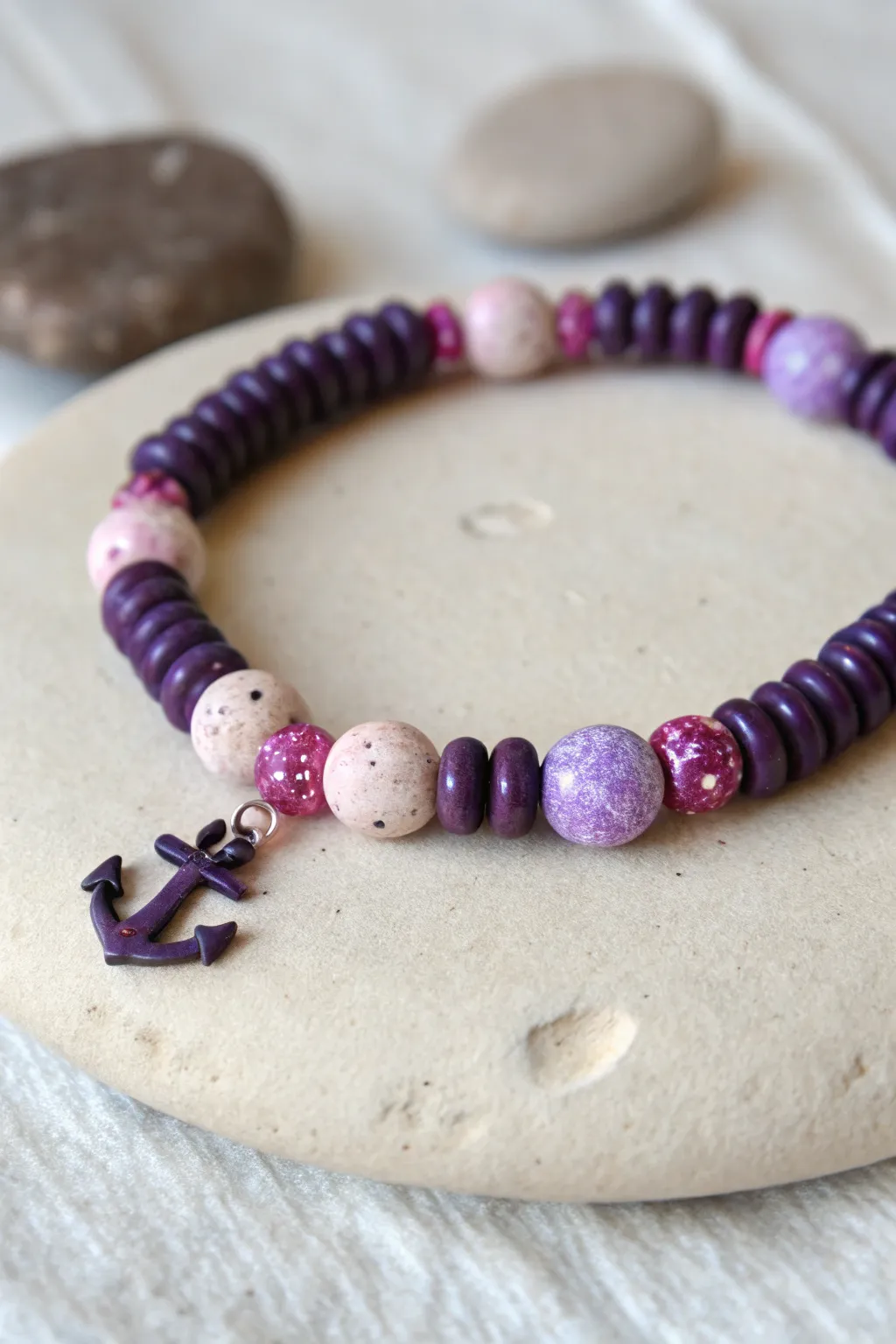 Deep purple clay beads with pink galaxy sprinkles and dark anchors for a dreamy minimal bracelet