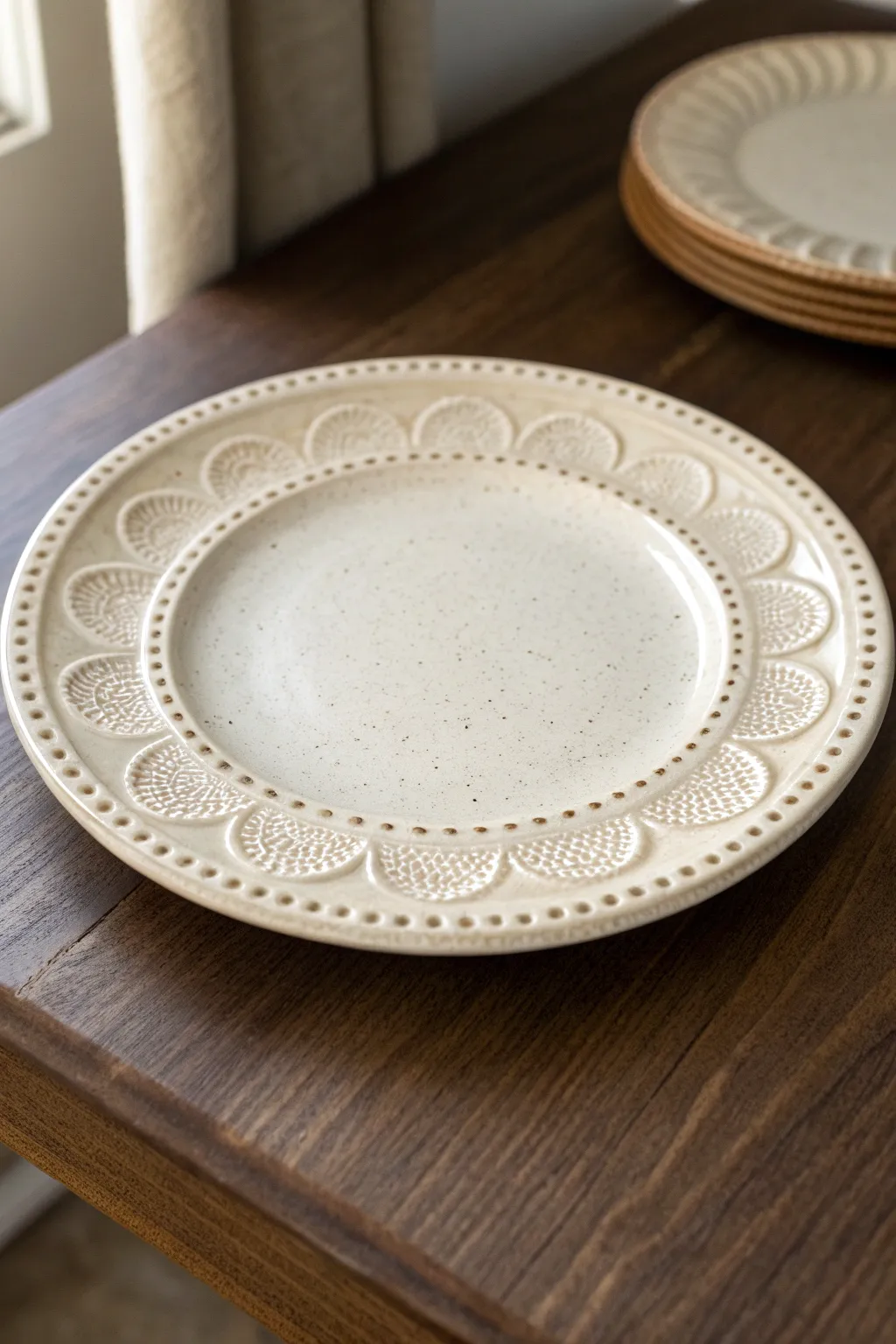 Delicate raised slip dots and lace loops along the rim create a cozy, tactile plate finish.