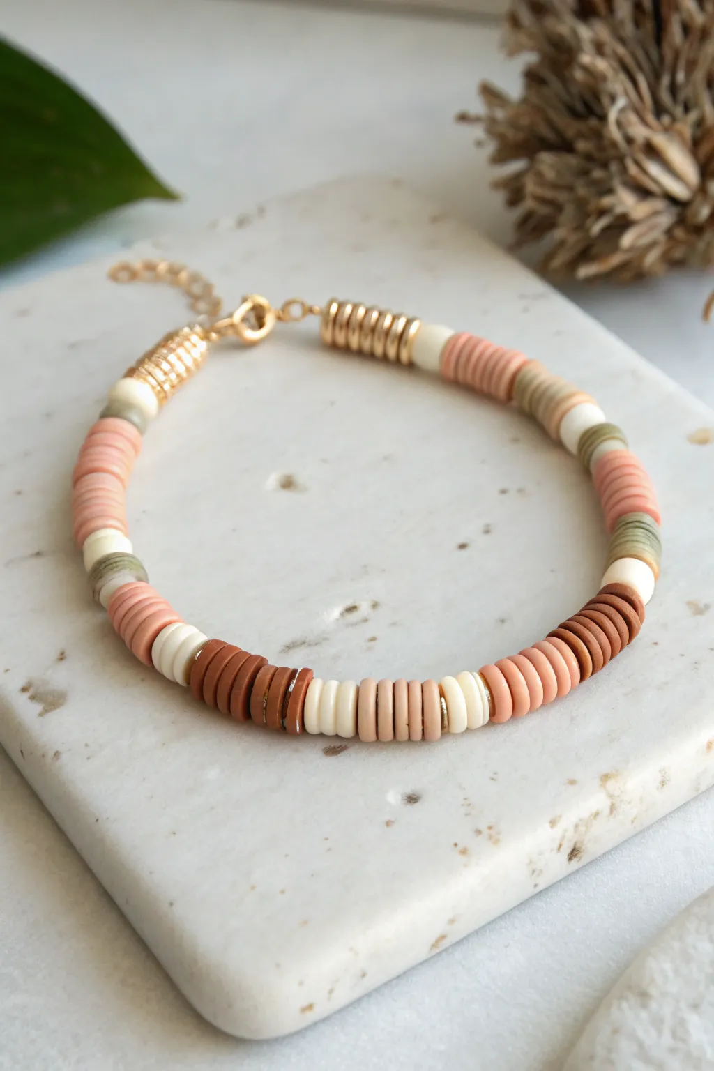 Minimal heishi bracelet with a pop of marbled swirl beads, perfect for easy clay accents.