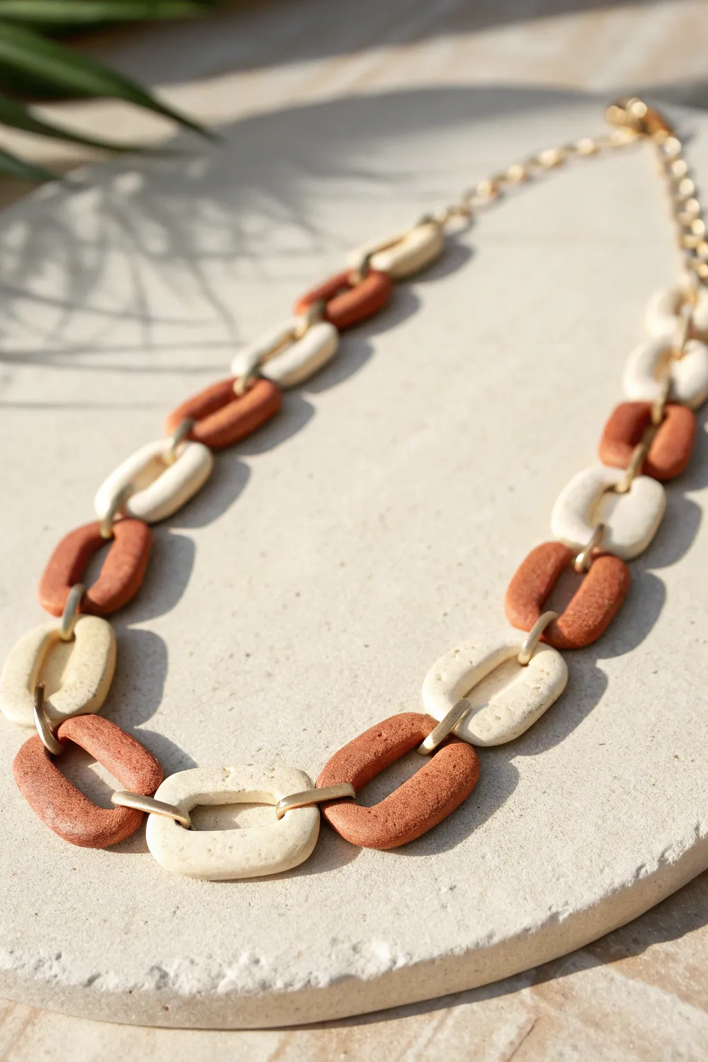 Two-tone crackle-effect polymer clay link necklace styled in a soft minimalist Scandinavian flat lay.