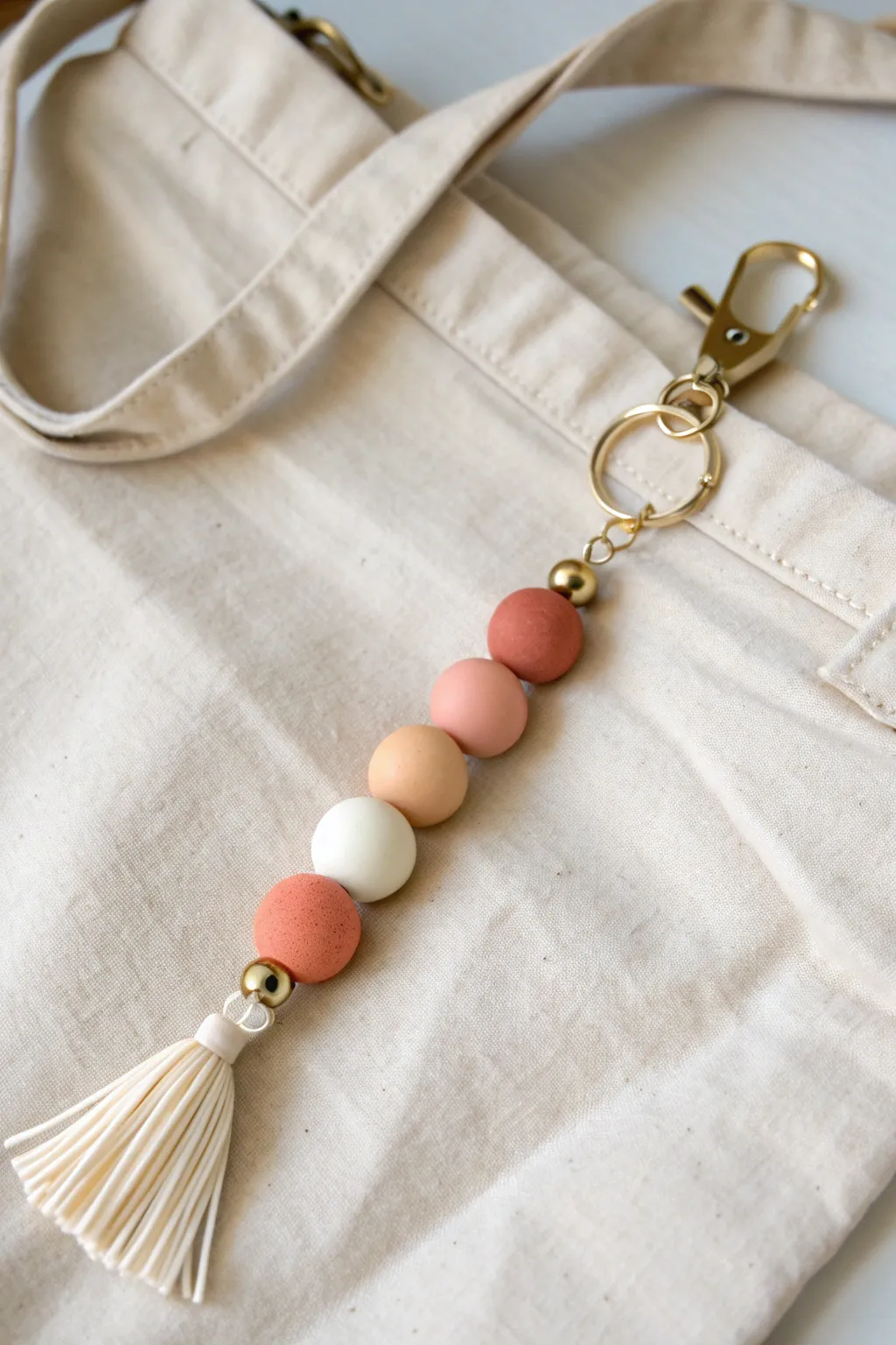 Chunky polymer clay beads in soft earthy tones with a simple tassel for an easy boho keychain.