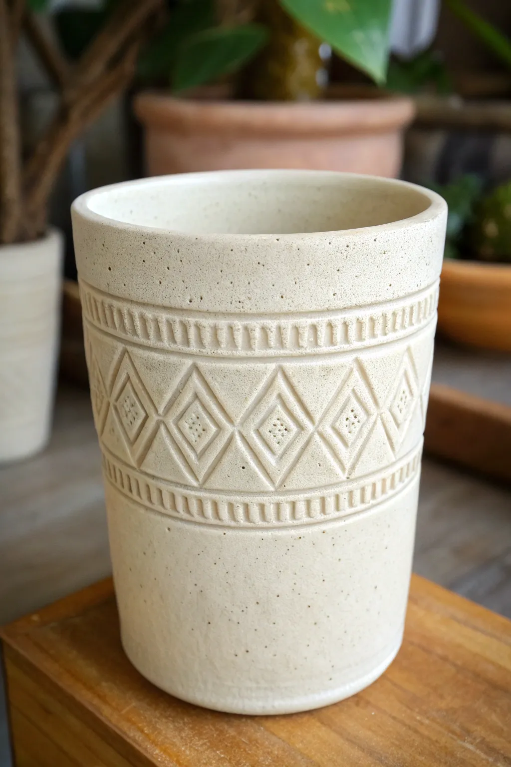 Minimal stoneware cup with tile-inspired geometric carving for crisp, modern texture