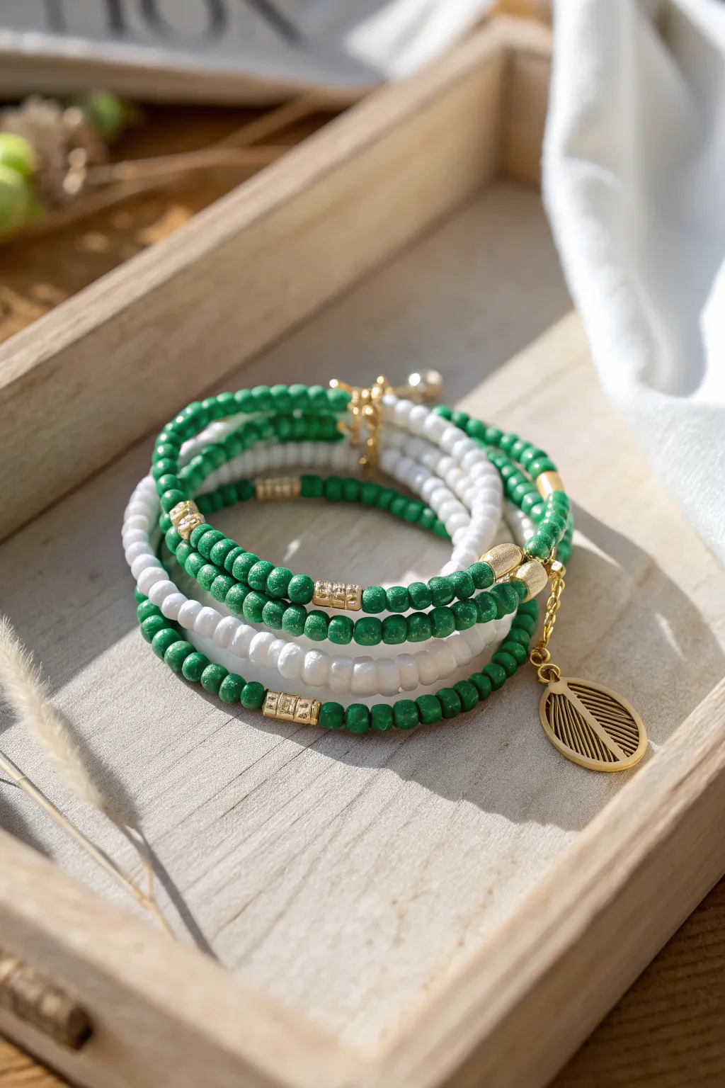 Tennis club inspired green and white clay bead stack with a tiny gold charm, crisp and chic.