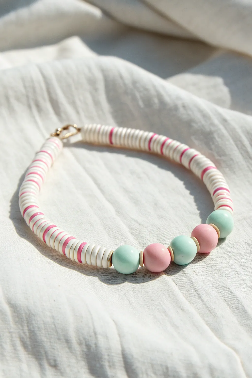 Preppy clay disc bead bracelet with micro-stripe repeats in white, pink, and mint.