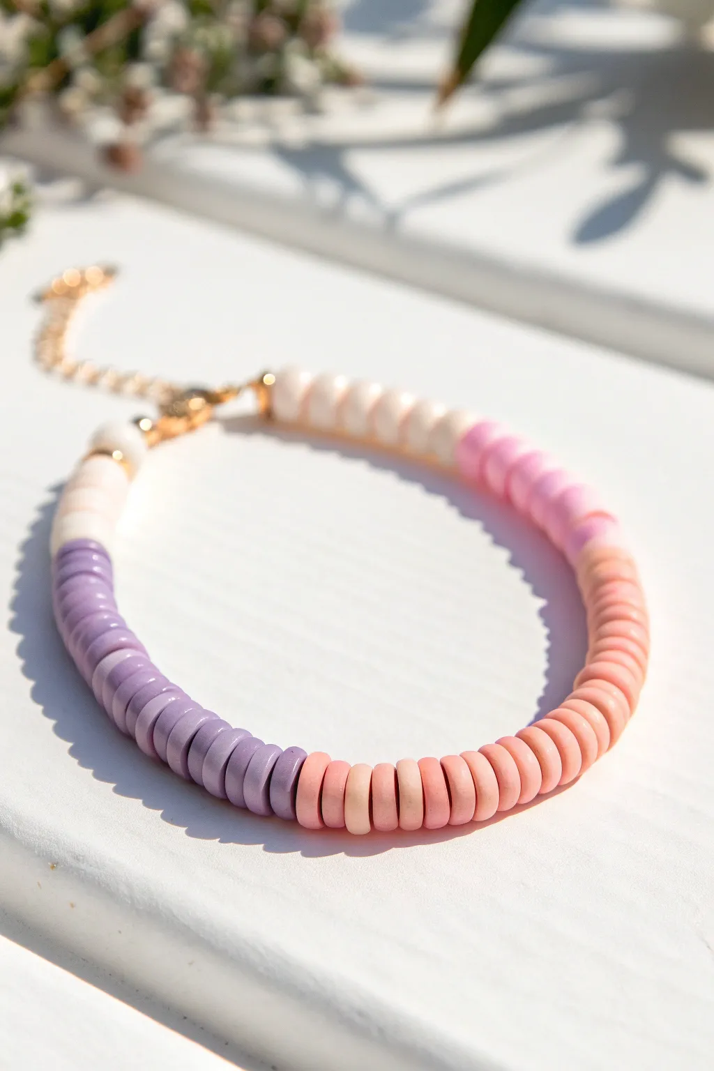 Pastel sorbet ombré heishi bracelet fading lavender to pink to peach, clean and minimal.