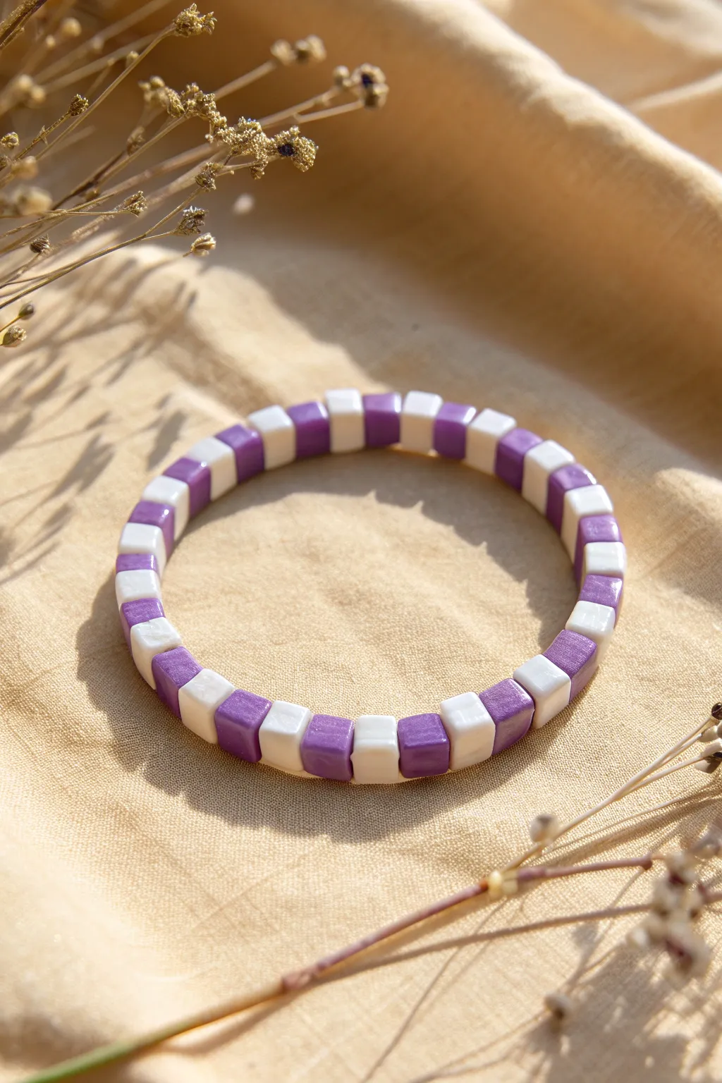 Purple-and-white checker stripe clay bracelet with minimalist Scandinavian charm and crisp contrast.