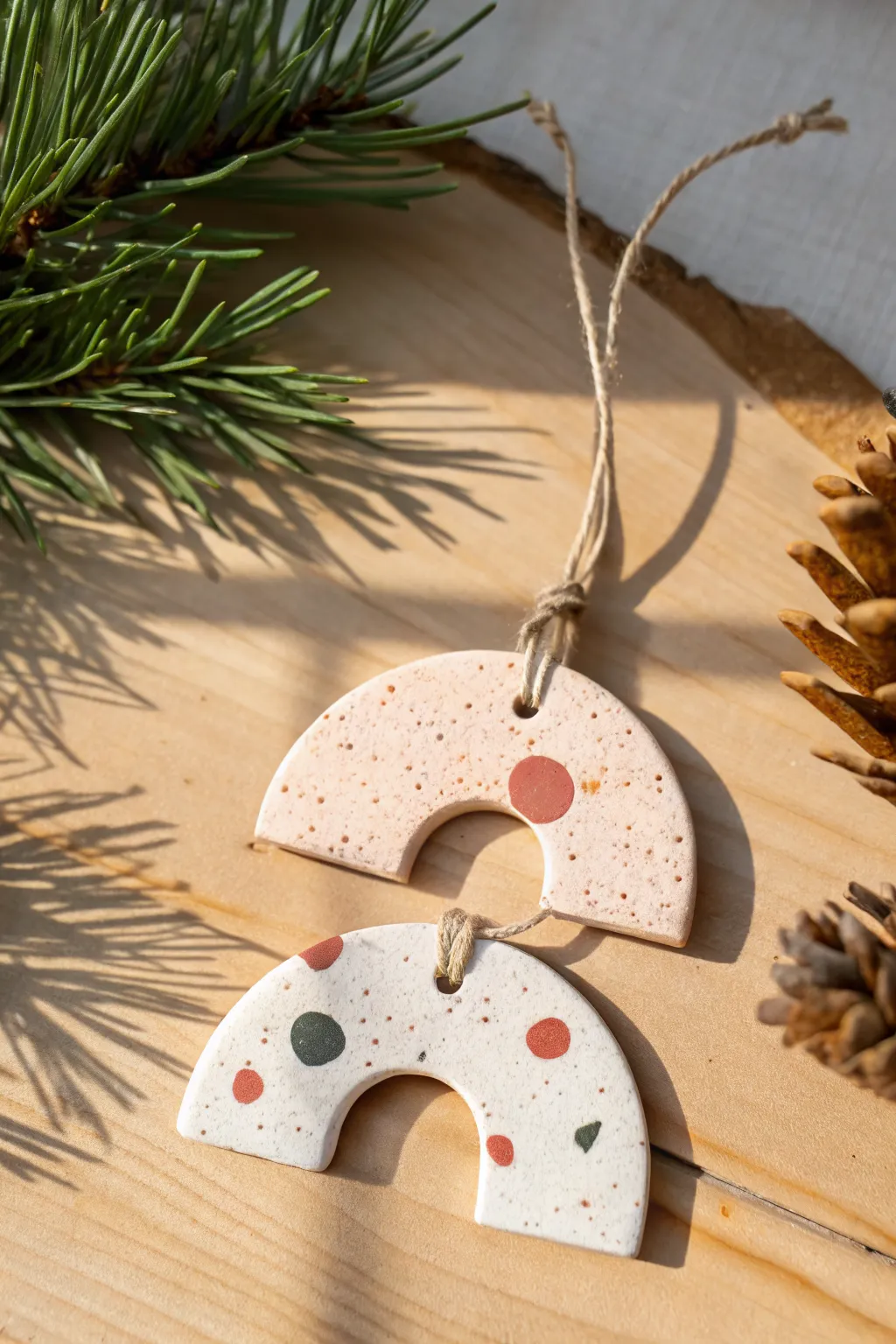 Minimal terrazzo speckle clay ornament in soft holiday hues, clean lines and cozy boho charm