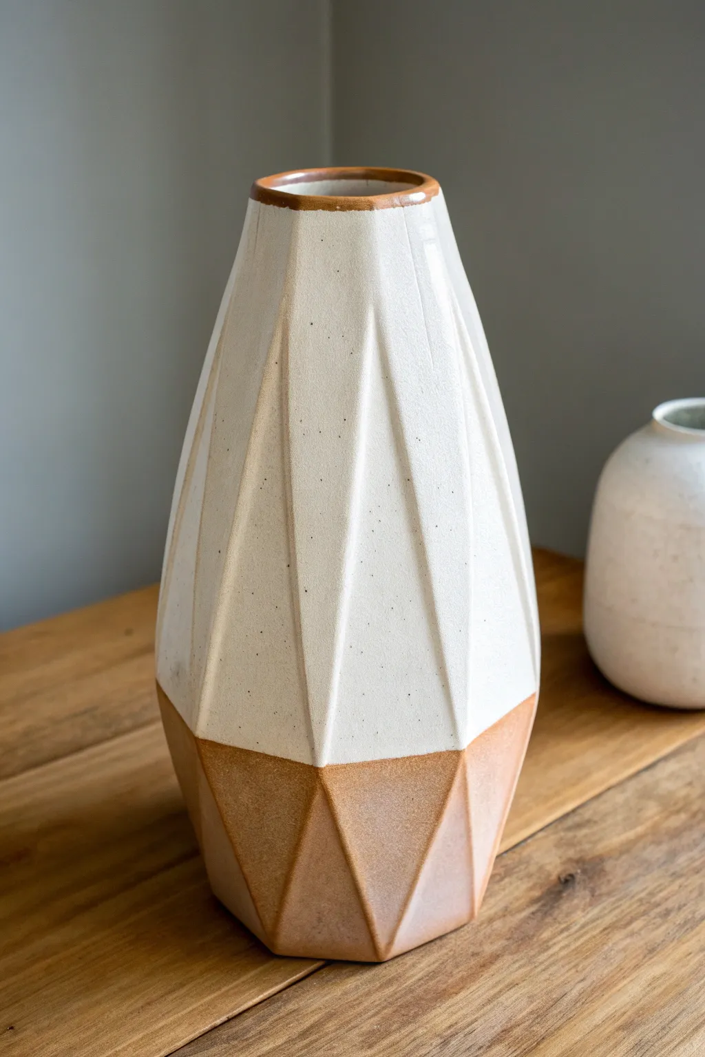 Two-tone glaze blocking on a geometric slab vase for modern lines and handmade warmth.