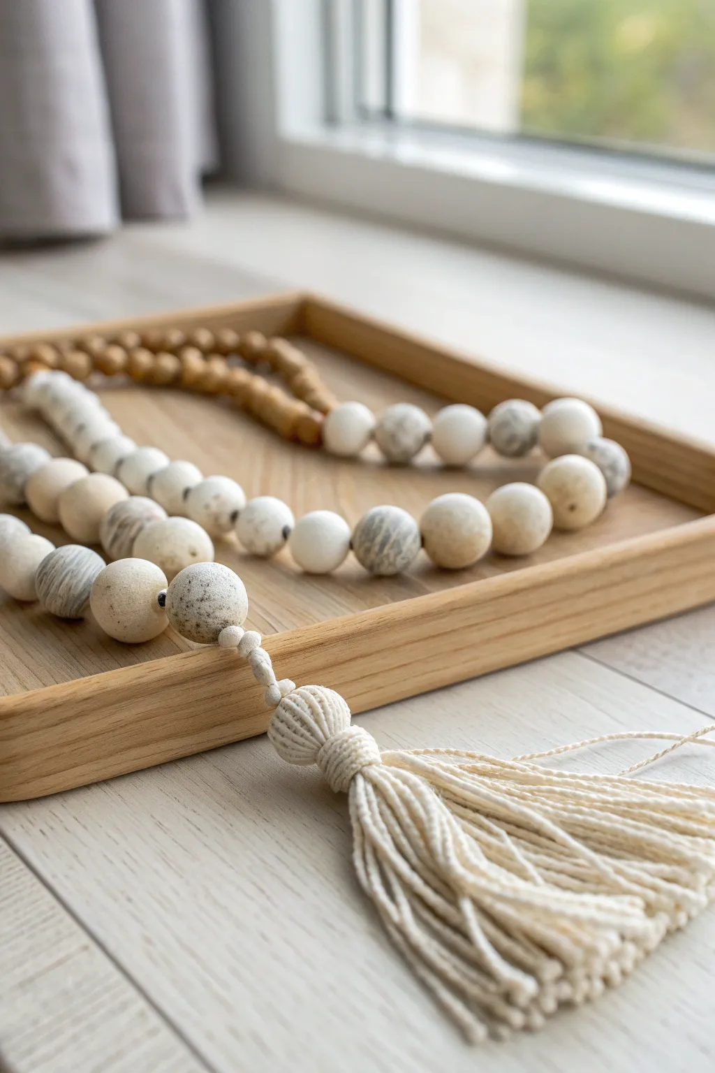 Minimal marble-effect air dry clay bead garland with tassel for cozy Scandinavian decor.