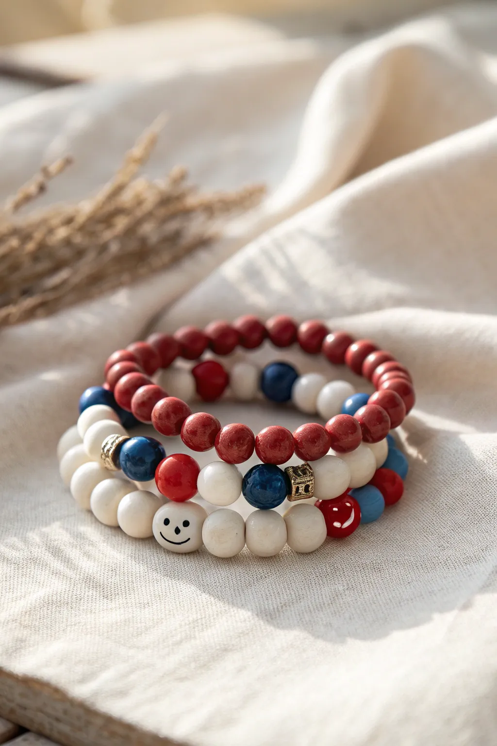 Parade Day stack: a red, white, and blue smiley bracelet with simple clay bead companions