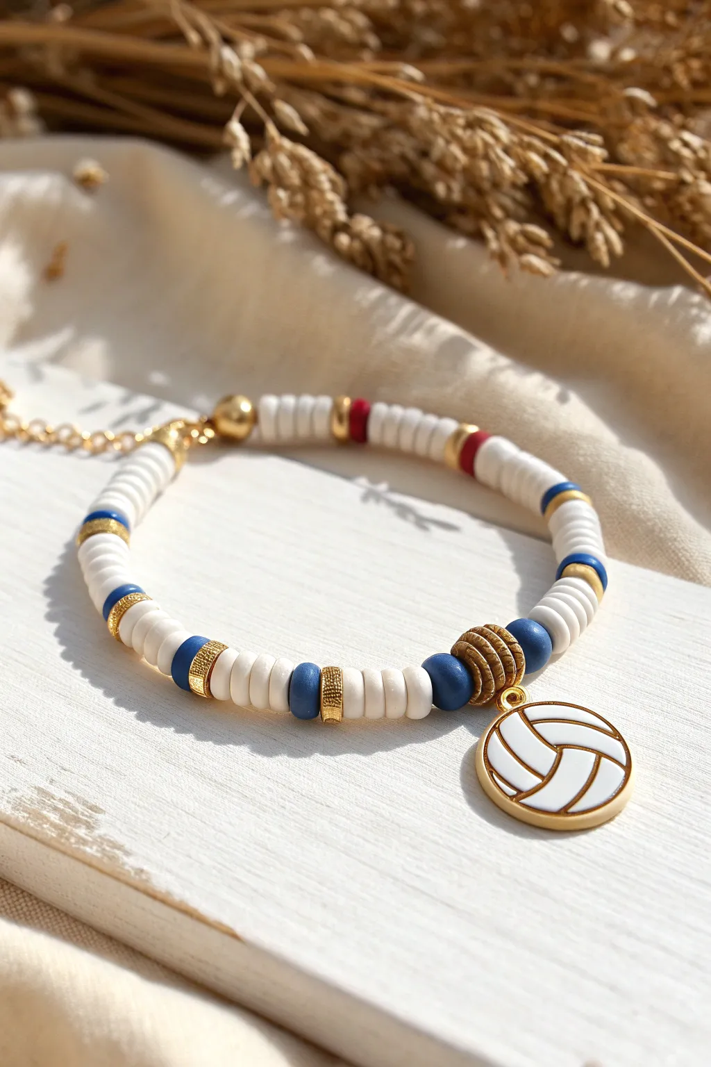 Sporty-meets-chic heishi bracelet with metallic spacers and a cute volleyball accent bead.