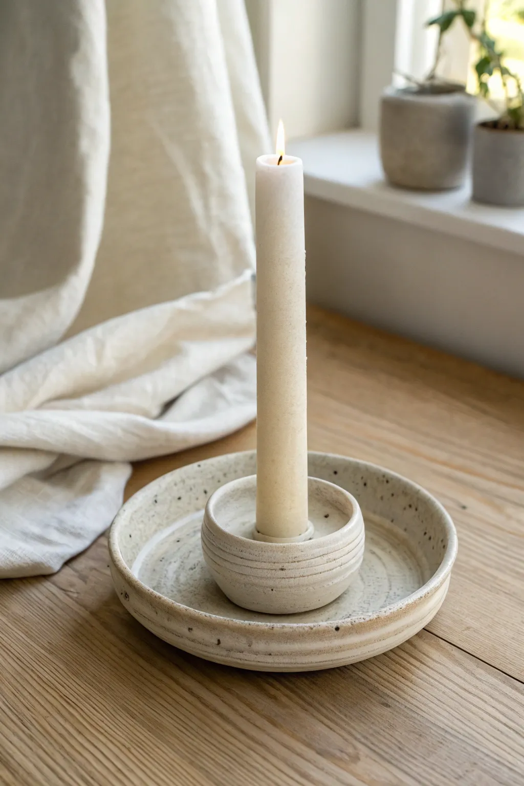 Wheel-thrown candle holder with drip dish in matte stoneware, minimalist and softly boho.