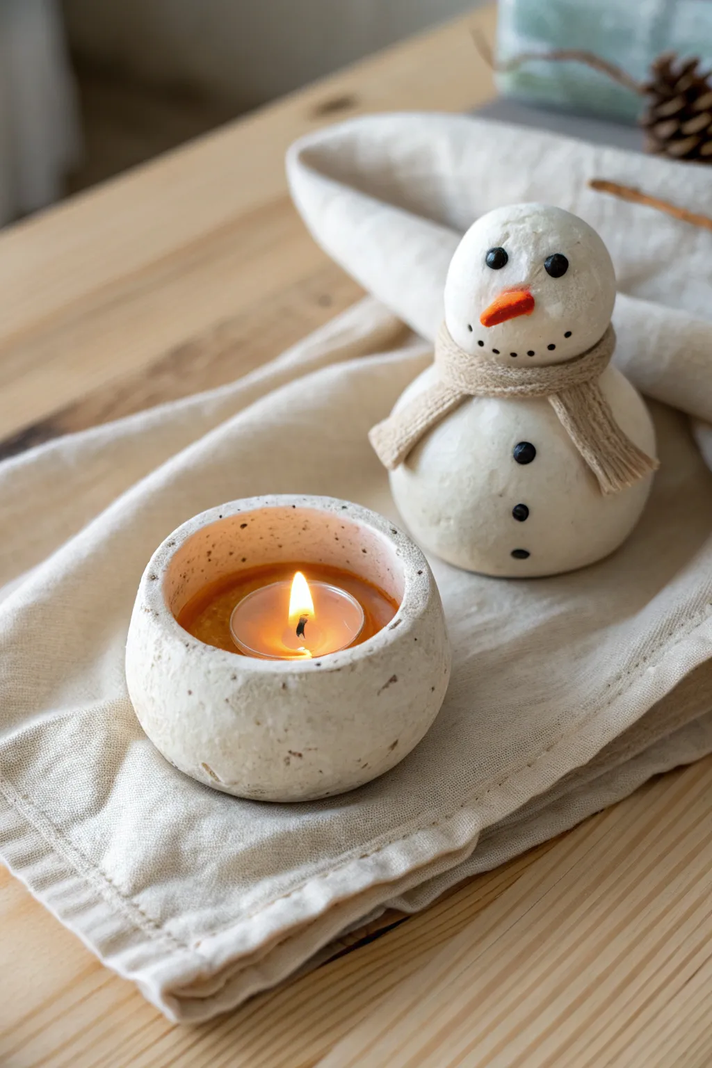 Minimal melting snowman candle holder in warm winter light, cozy glow and clean Nordic styling