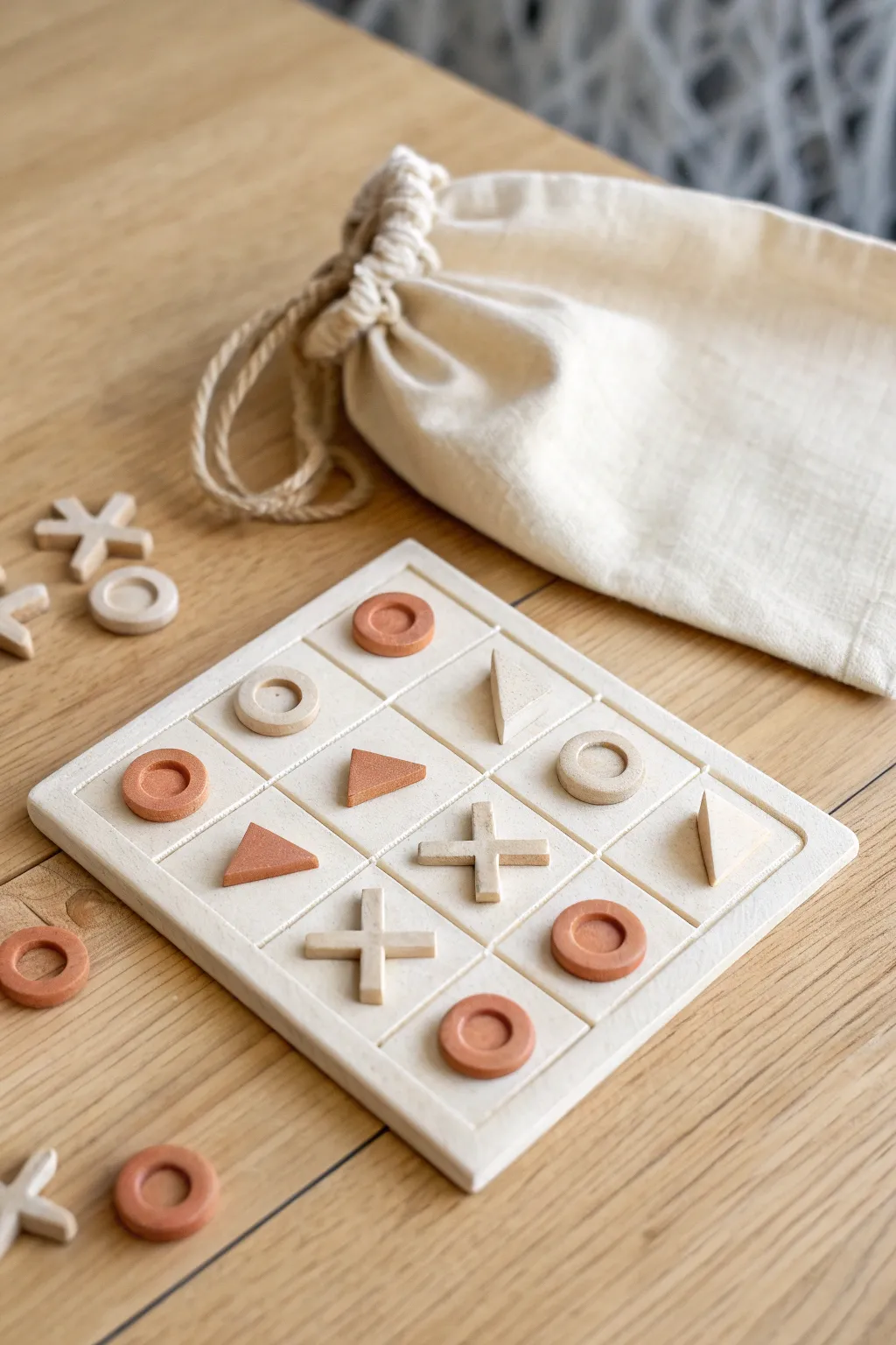 Mini air-dry clay tic tac toe travel set with tiny pieces and linen pouch, minimalist boho.