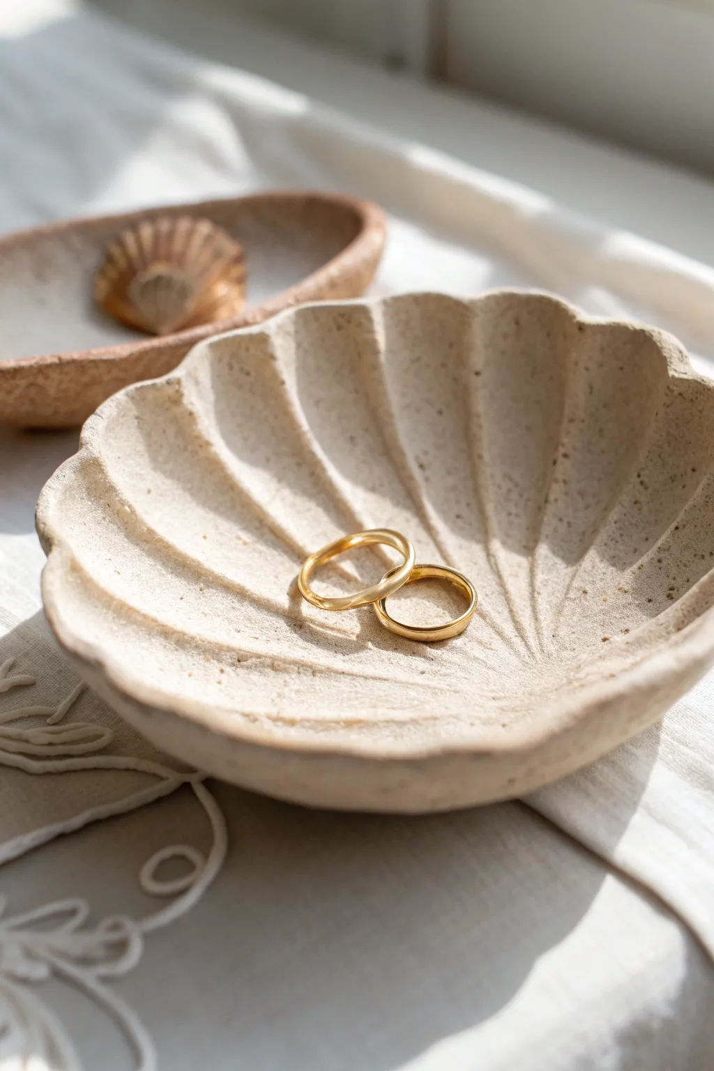 Sandy neutral shell dish made from air dry clay, a minimalist boho catchall for rings.