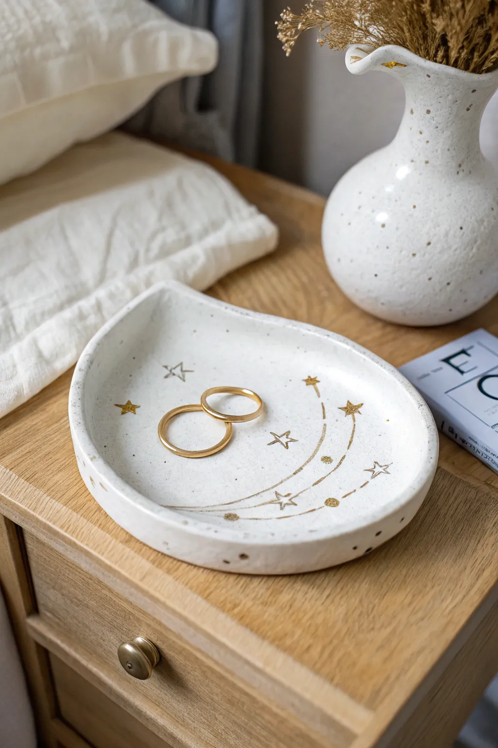 Crescent moon clay tray with star details, glossy finish, and ring stack for a dreamy nightstand.