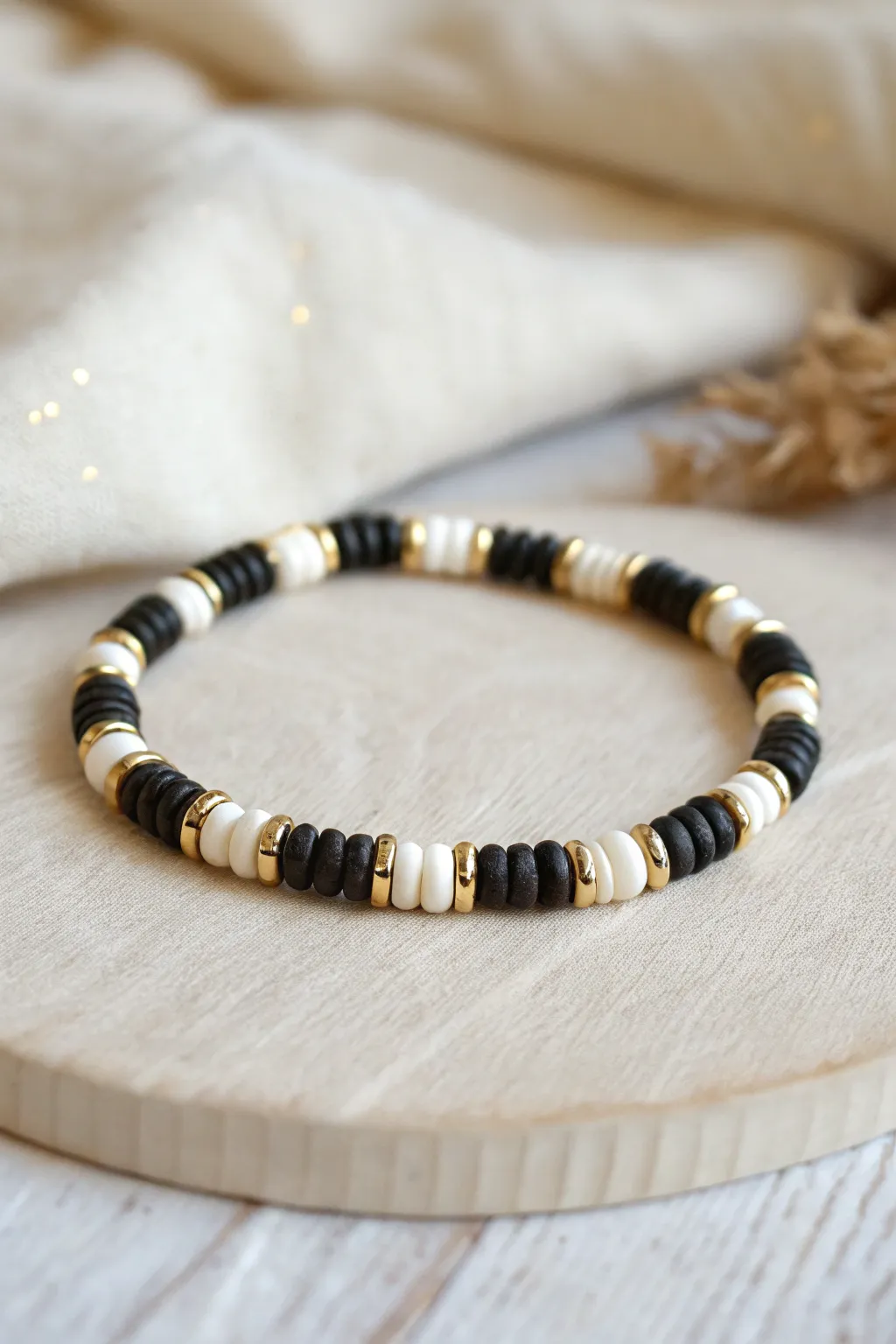 Black and white heishi bracelet with subtle metal spacers for a clean, modern rhythm.