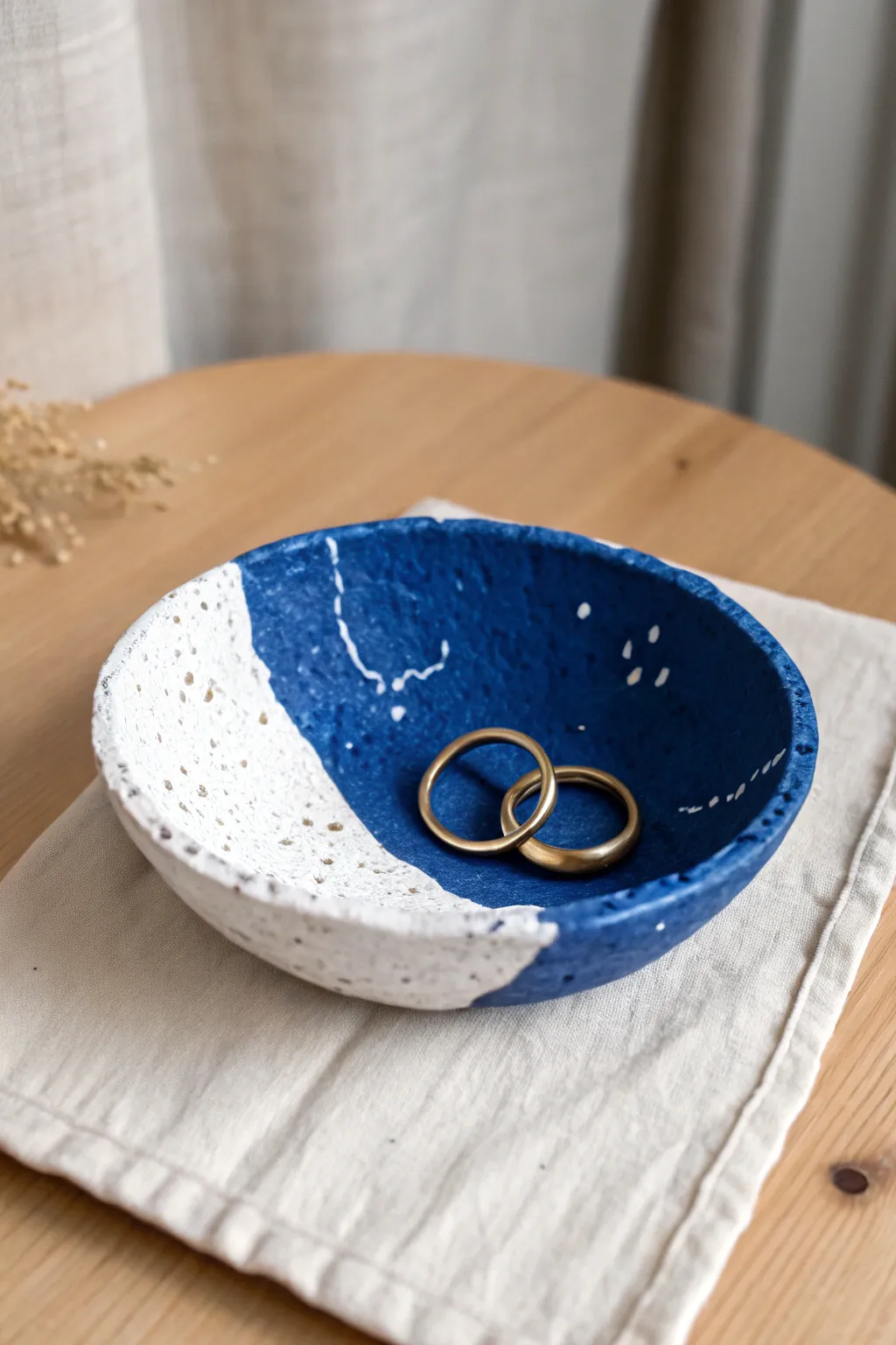 Deep blue pinch ring dish with a soft white splash, styled simply for calm boho minimalism.