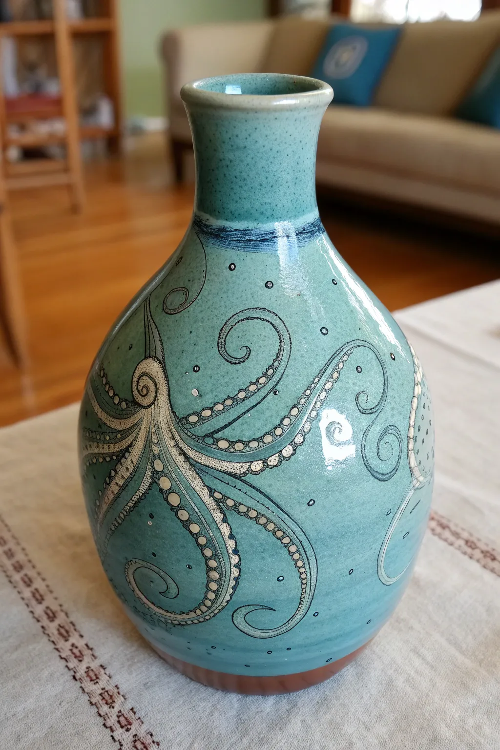 Ocean-glazed wraparound vessel with soft tentacle details, styled in calm minimalist tones