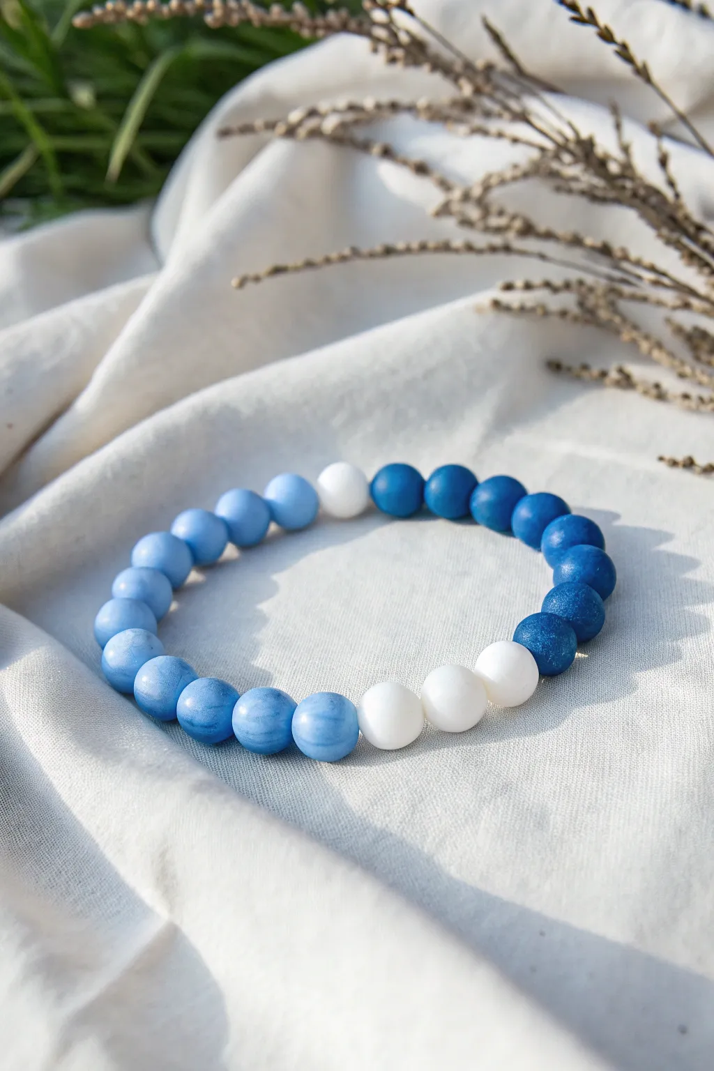 Wintery ombre clay bracelet in icy blue fading to snow white, minimal and handcrafted.