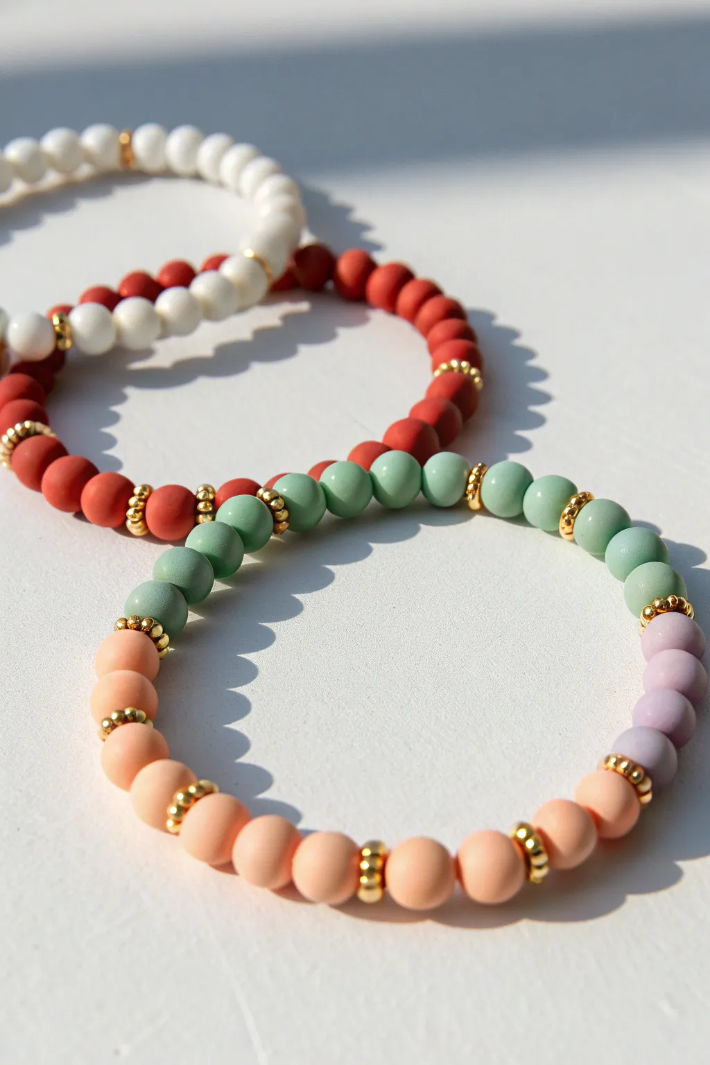 Three holiday color combo clay bead bracelets with minimalist charm and handmade texture.