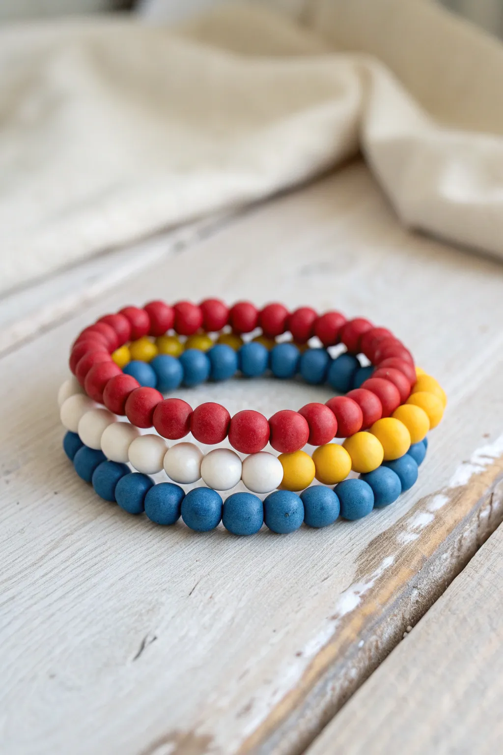 Primary colors made calm: clay bead bracelets with white spacers for balanced, easy recipes.