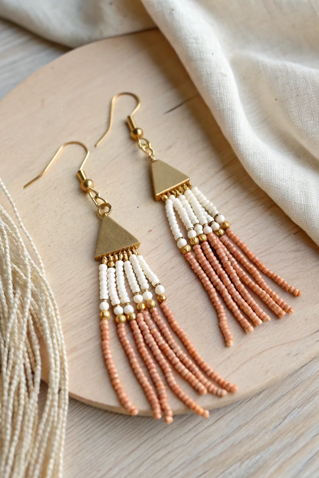 Minimalist clay heishi fringe earrings with tidy multi-strand movement in soft neutral tones