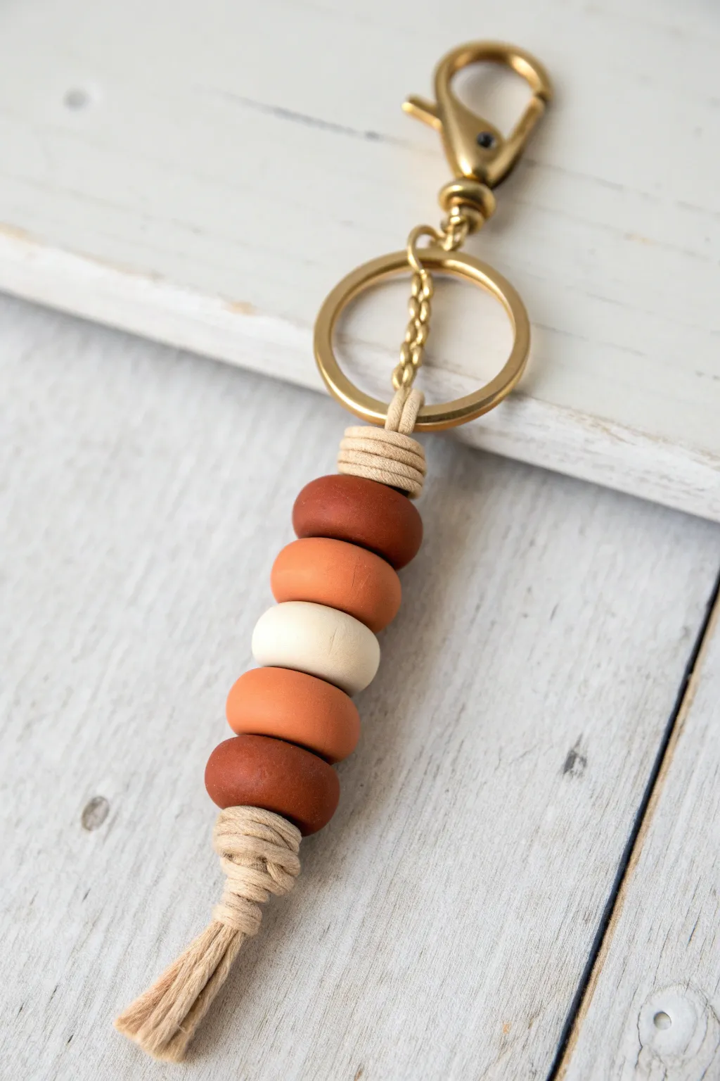 Hidden knot finish under a statement bead for a clean, polished clay bead keychain look