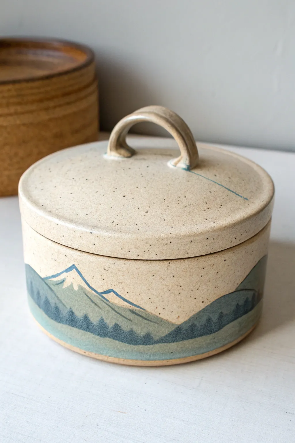 Minimal mountain-lid clay box with calm sky bands for a modern cabin-inspired storage piece