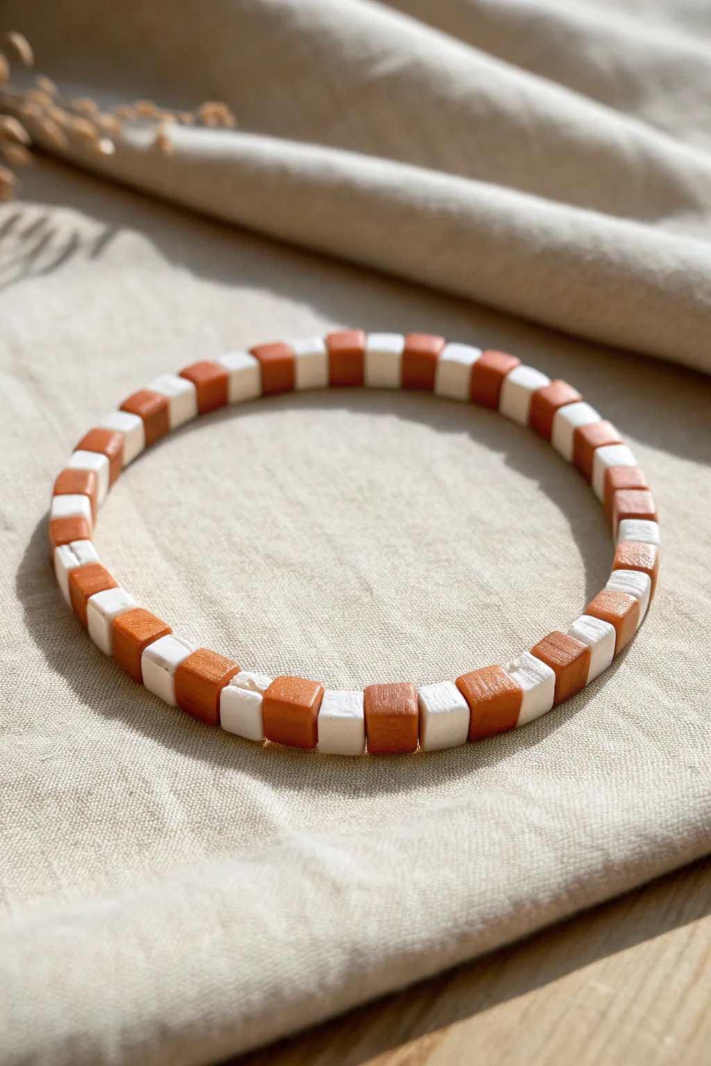 Two-tone clay heishi bracelet with a crisp checkerboard pixel pattern, simple and chic.