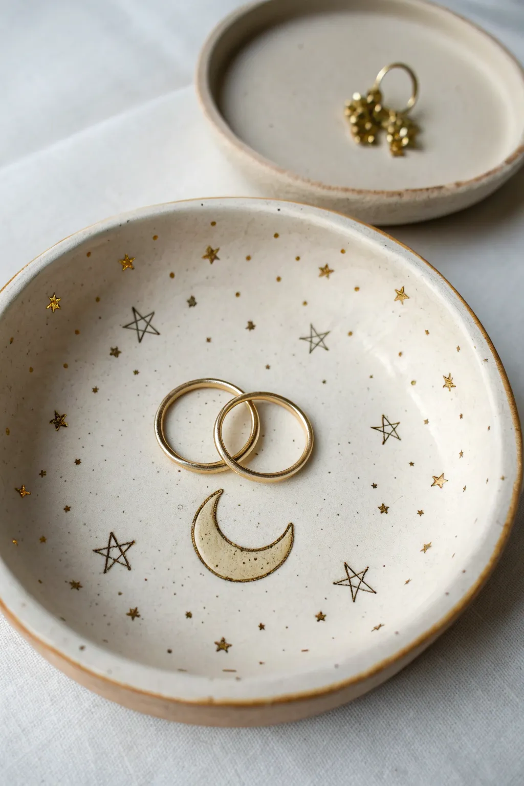Celestial moon and stars clay ring dish with soft gold accents and minimalist Scandi charm.