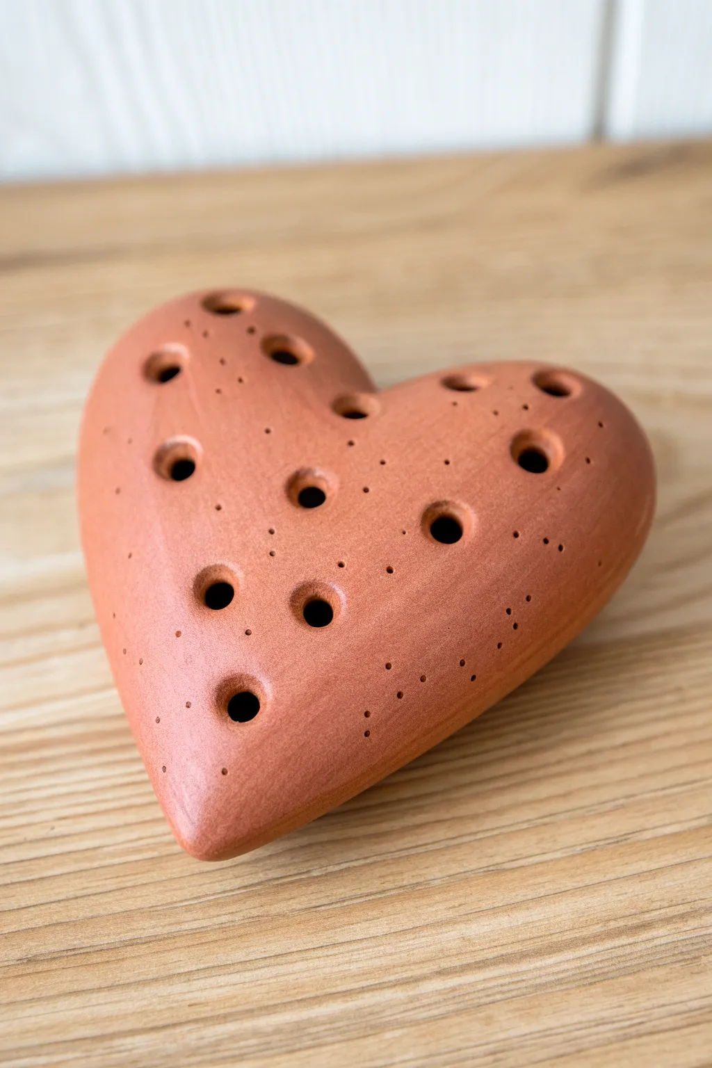 Blush heart pocket ocarina with tidy finger holes, minimal styling and warm handcrafted charm