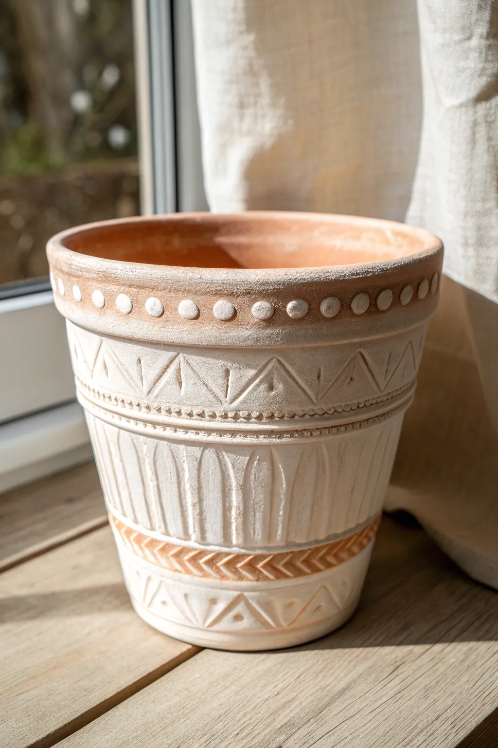 Simple raised bands turn a painted terracotta pot into a tactile minimalist statement piece