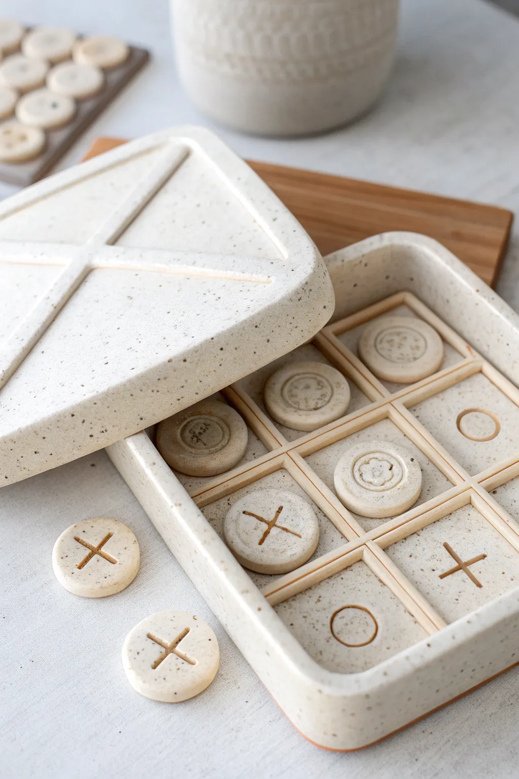 A gift-ready clay tic tac toe travel set with a neat built-in pocket for storing pieces.