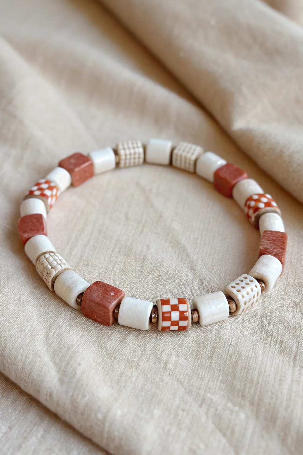 Minimal tile-pattern clay bracelet with checkerboard and marble sections, soft boho Scandinavian feel.