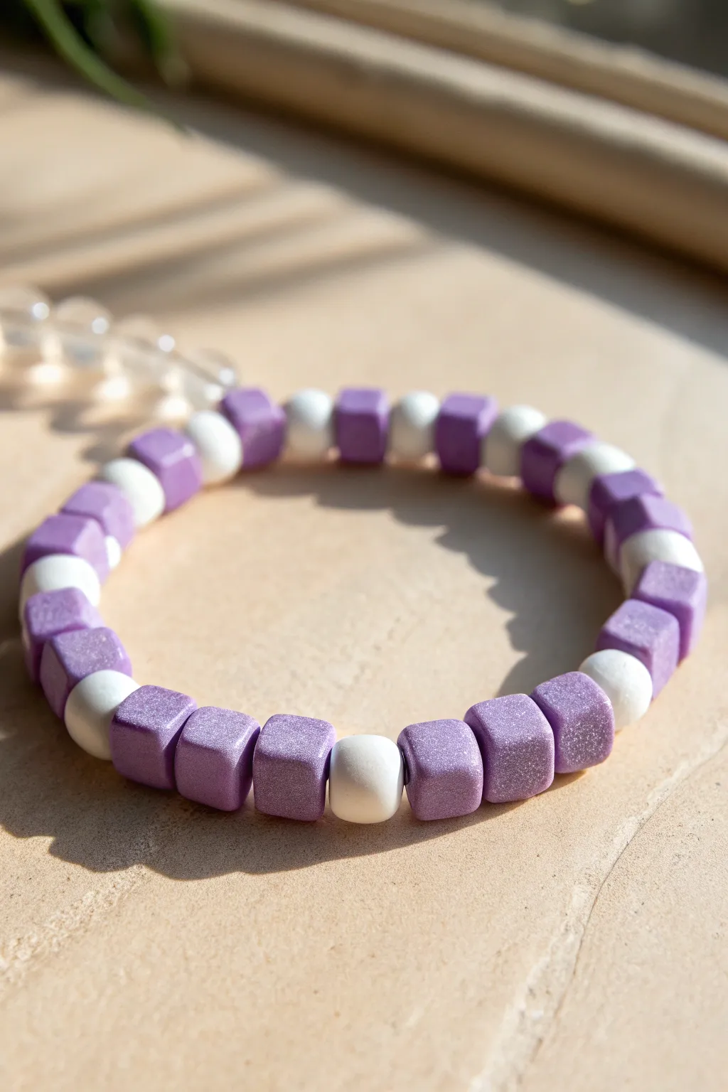 Lavender and white checkerboard clay bead bracelet that pops on a clean minimalist background.