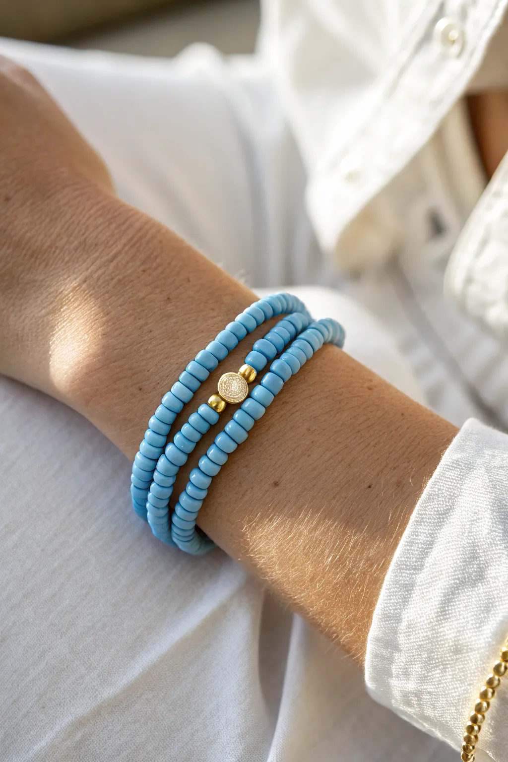 Double-strand blue clay heishi wrap bracelet, twice-around style with a small accent bead.