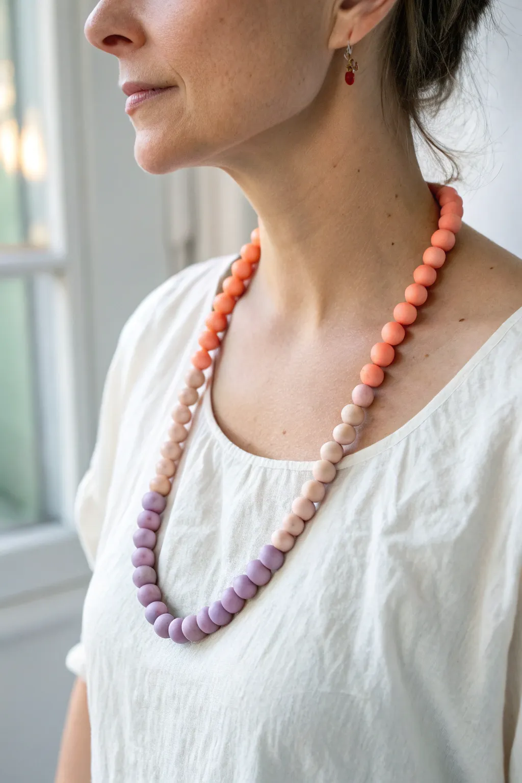 Warm ombre clay bead necklace from peach to coral to lavender for an effortless sunset look.