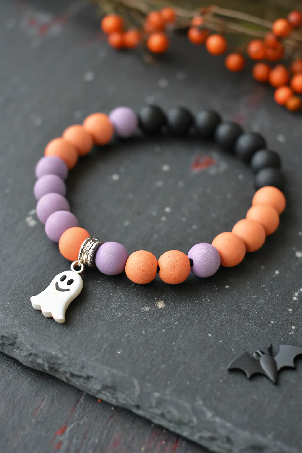 Sweet spooky fall bracelet in black, lavender, and pumpkin orange with ghost and bat charms