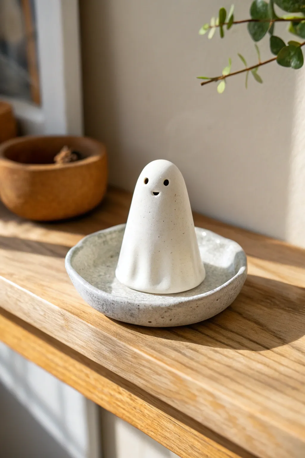 Minimal ghost incense holder in matte white clay, a cute and useful handmade shelf accent.