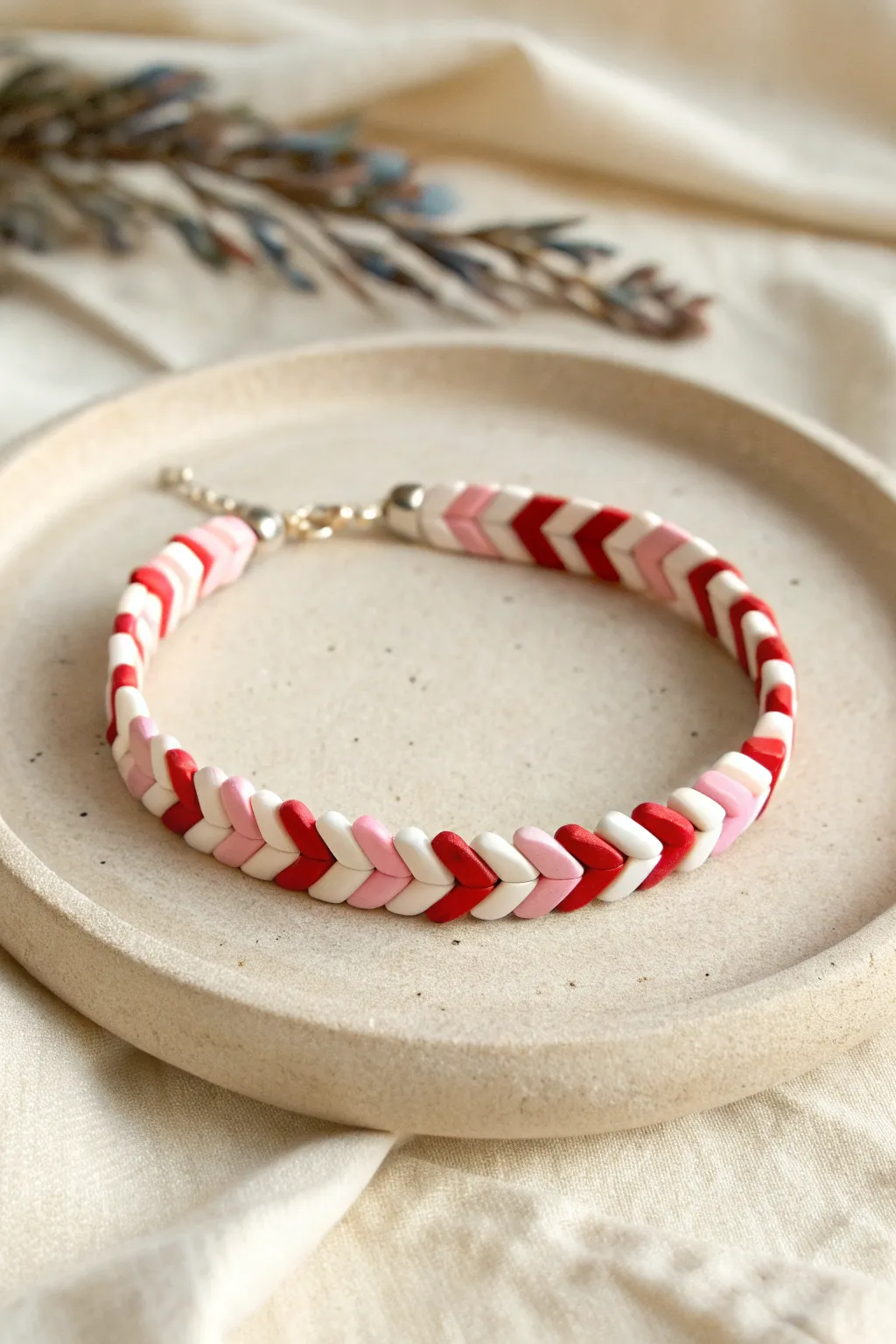 Cupid arrow chevrons in red, blush, and cream for a bold, easy Valentines clay bead bracelet
