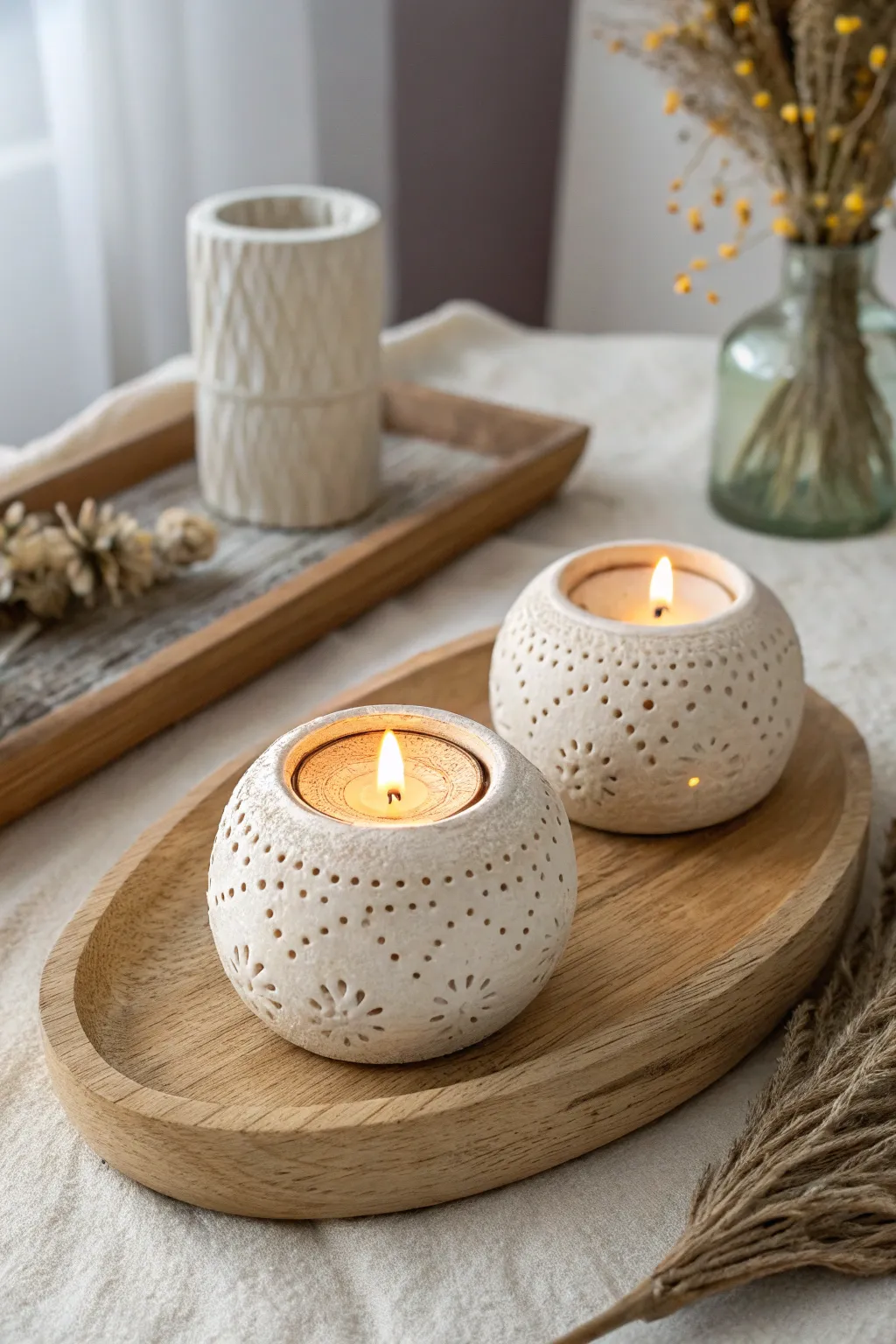 Two tiny handmade tea light holders, soft glow and simple stamped texture for a cozy date night.
