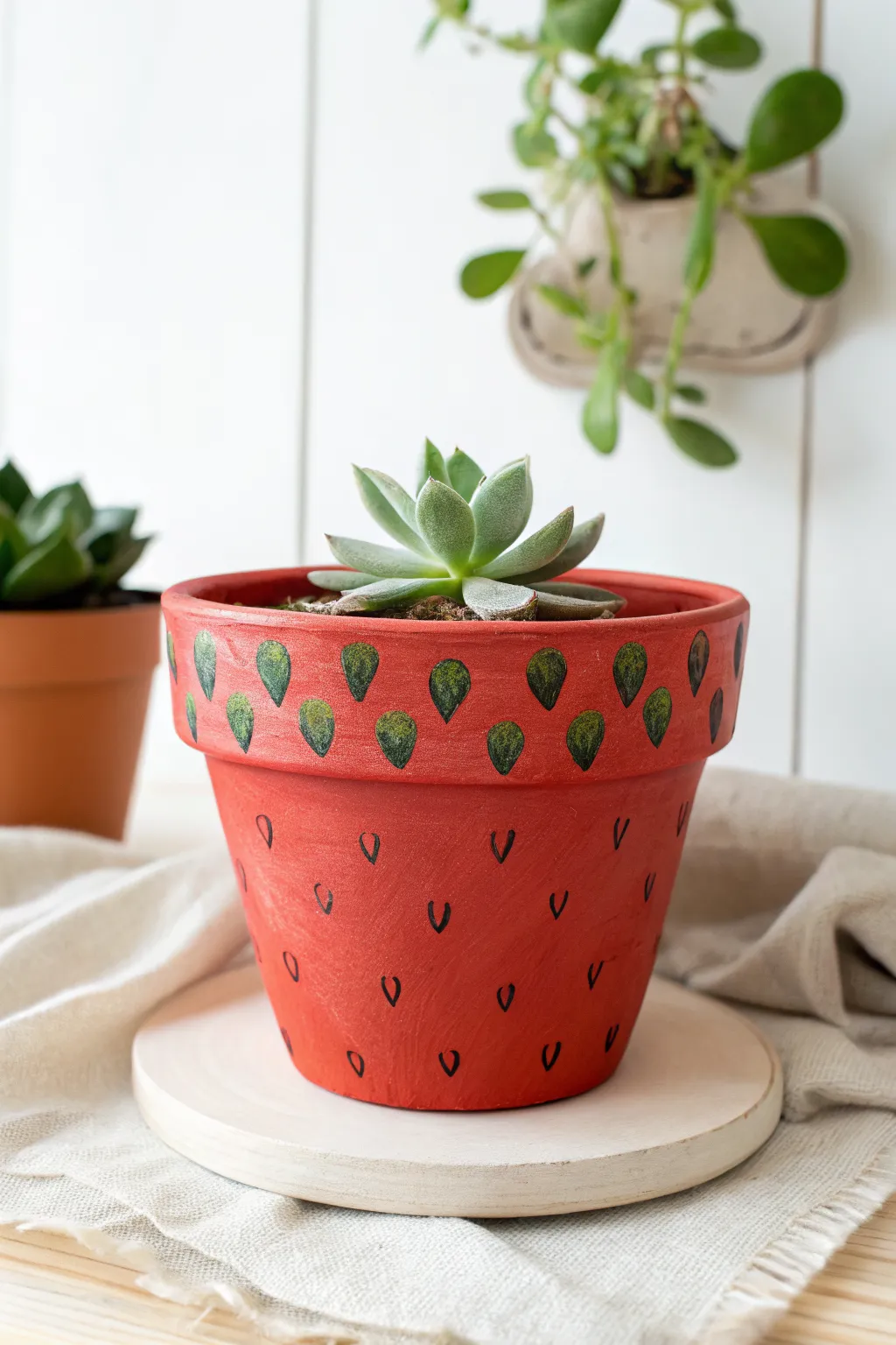 Strawberry clay pot planter with a tiny succulent, minimal Scandinavian-boho styling and crisp contrast